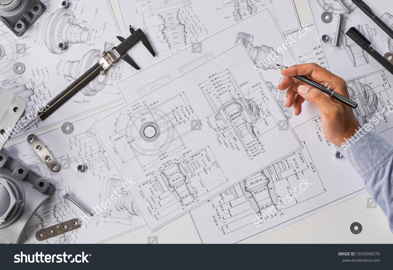 Engineer technician designing drawings mechanical parts engineering Engine
manufacturing factory Industry Industrial work project blueprints measuring bearings caliper tools #1593096079