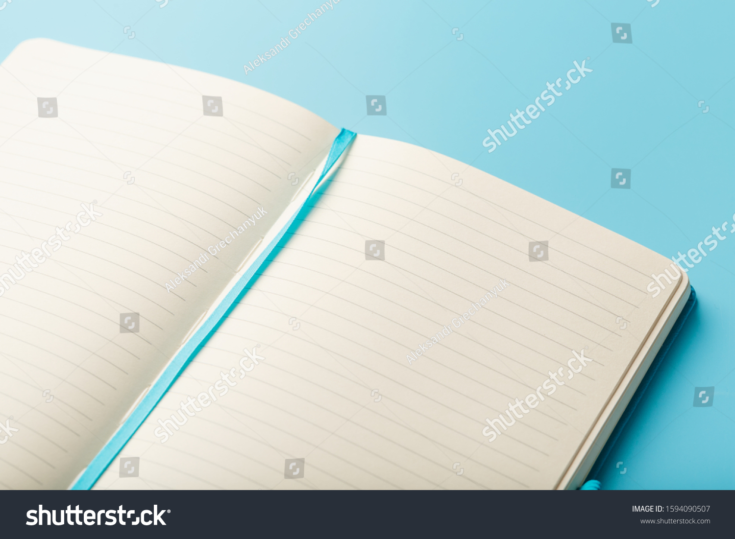 Open notebook, diary with blank and blank pages on a blue background, top view. #1594090507