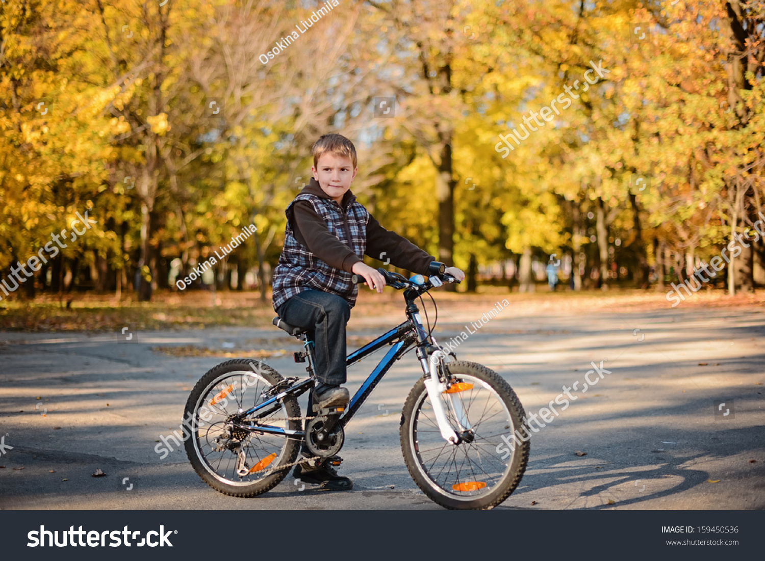 Cute boy cycling in autumn park  #159450536