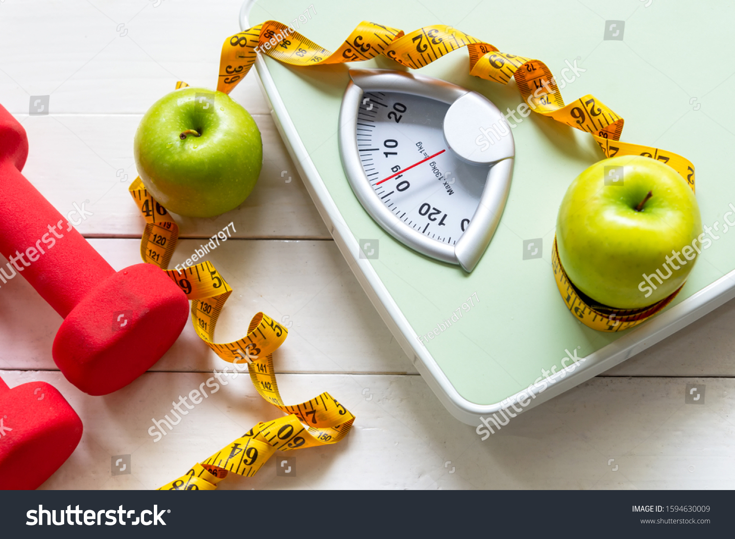 Diet and Healthy life loss weight Concept. Green apple and Weight scale measure tap with fresh vegetable and sport equipment for women diet slimming.  #1594630009