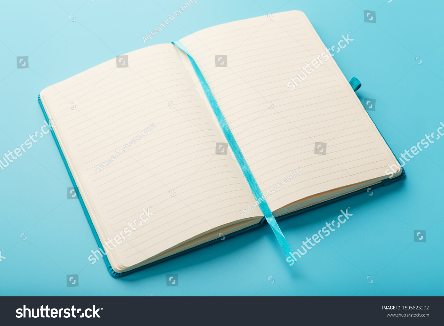 Open notebook, diary with blank and blank pages on a blue background, top view. Layout for design, free space #1595823292