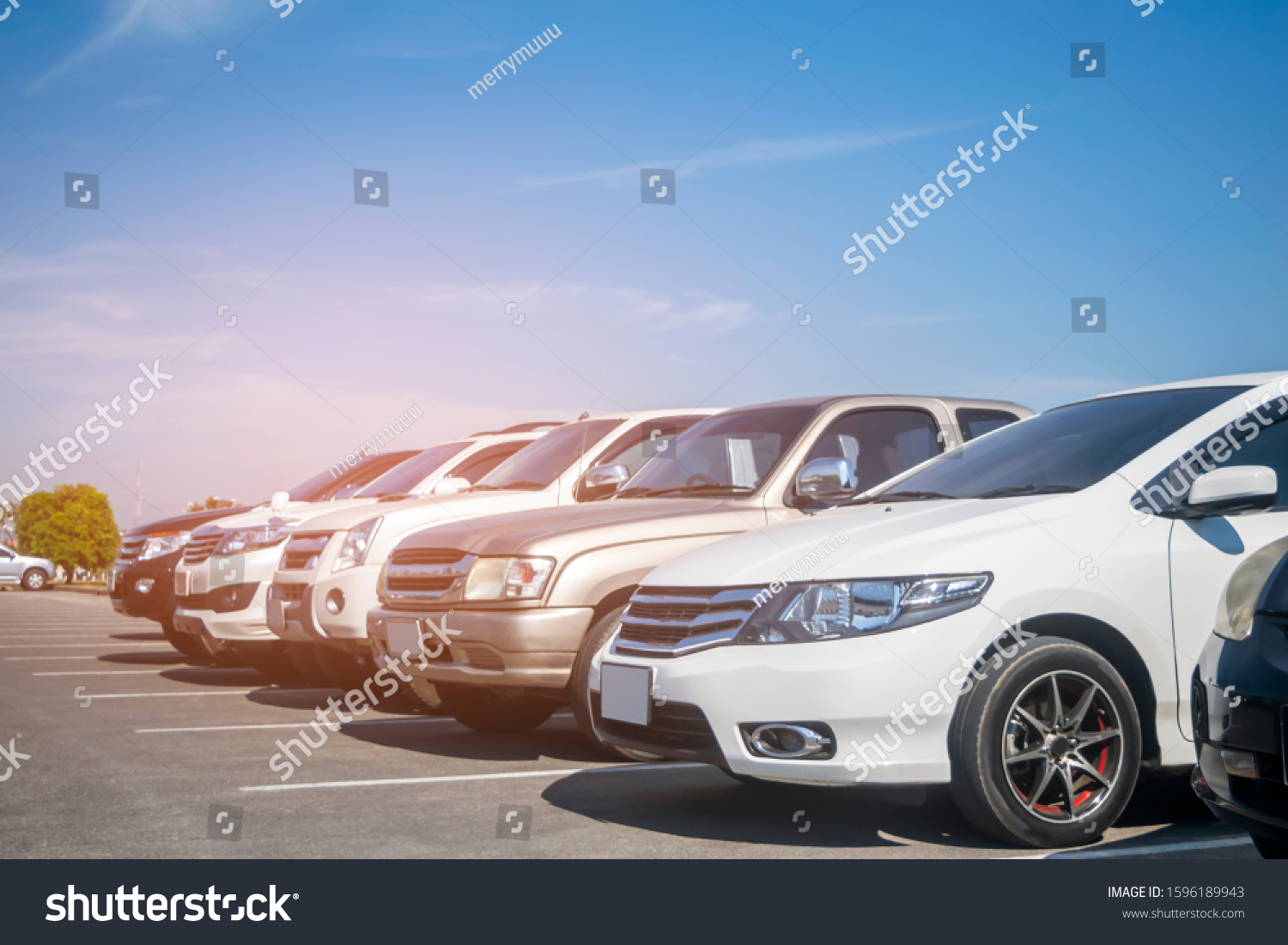 Cars parking in asphalt parking lot in a row with blue sky background. Outdoor parking lot with fresh ozone, green nature environment of transportation and technology concept

 #1596189943