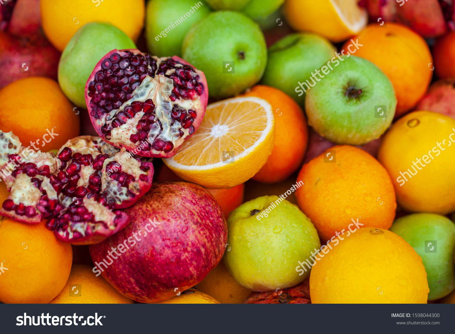 Fruit background, apples, opened pomegranate, orange, Delicious winter fruits on a stall, variety of healthy ripe fruits  #1598044300