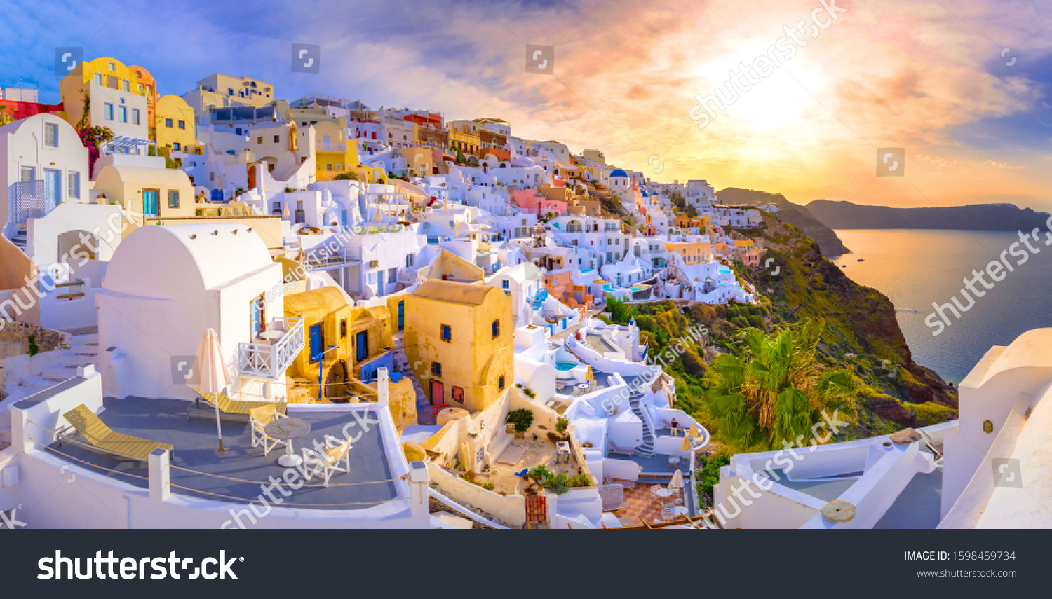 Oia town on Santorini island, Greece. Traditional and famous houses and churches with blue domes over the Caldera, Aegean sea #1598459734