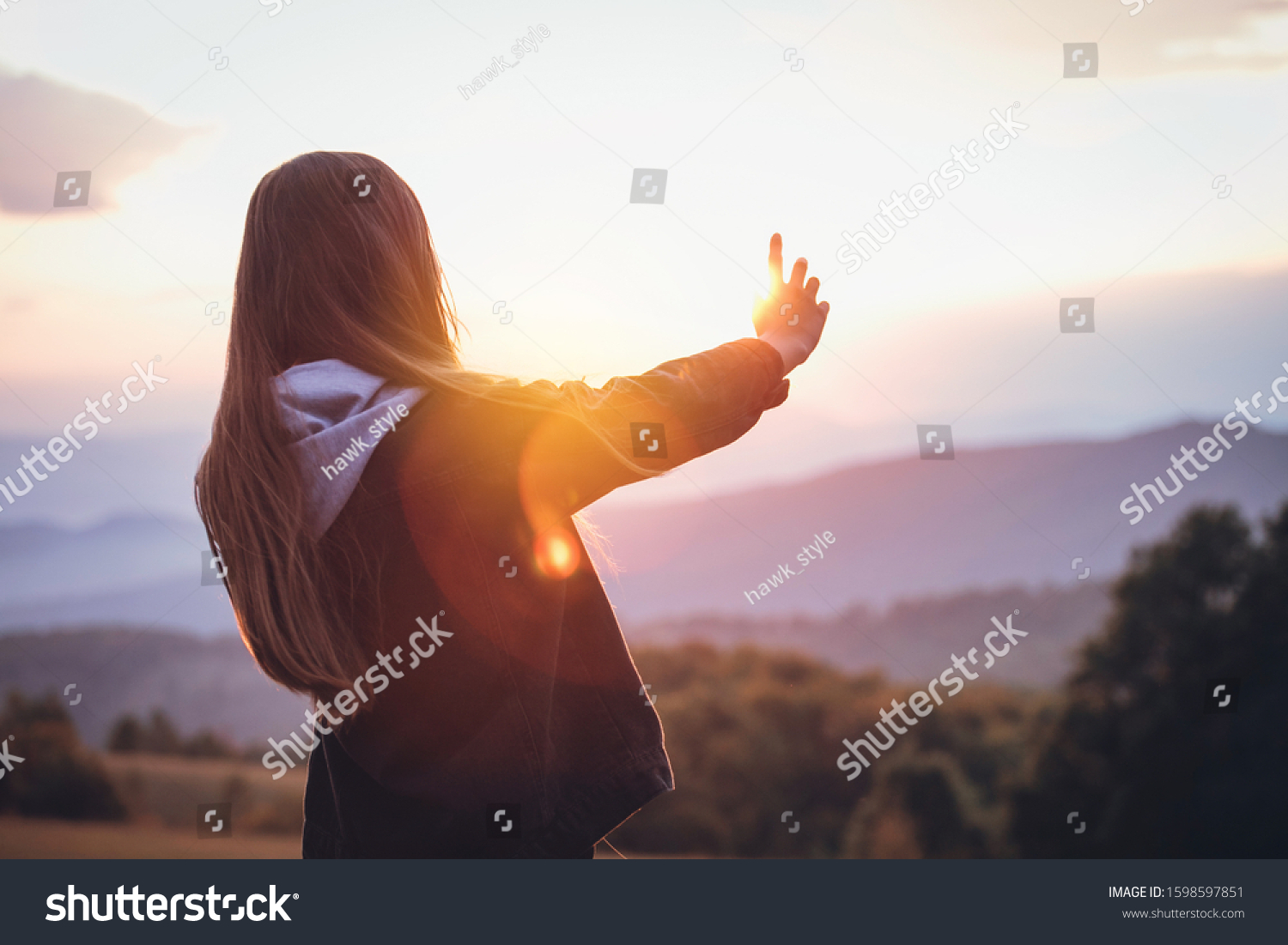 Young Prety Girl Outstretched Arm Covers the Sun #1598597851