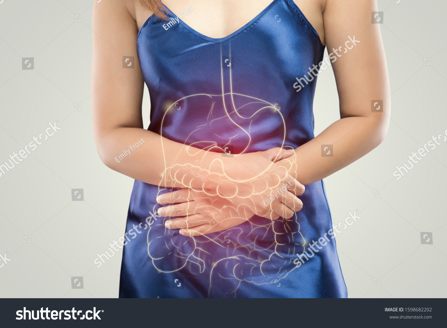 The photo of internal organs is on the woman's body against gray background, People With Stomach ache problem concept, Female anatomy #1598682202