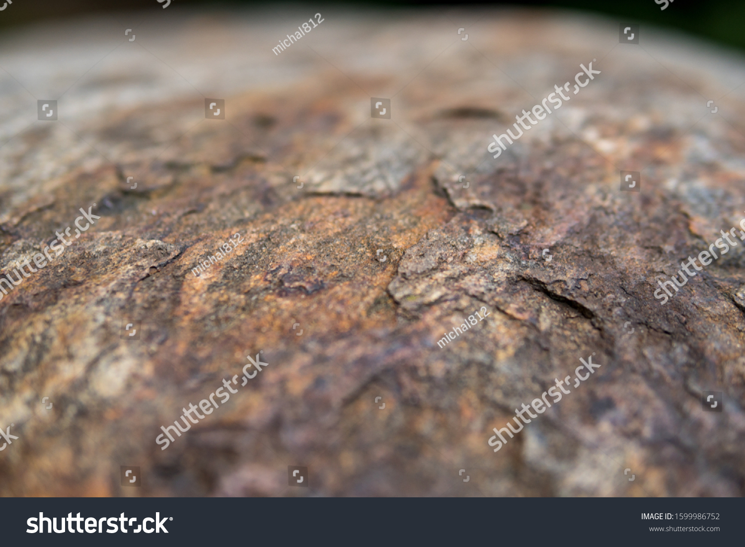 detail of a rock with effect of thermal stress weathering and visible layers peeled away by exfoliation #1599986752