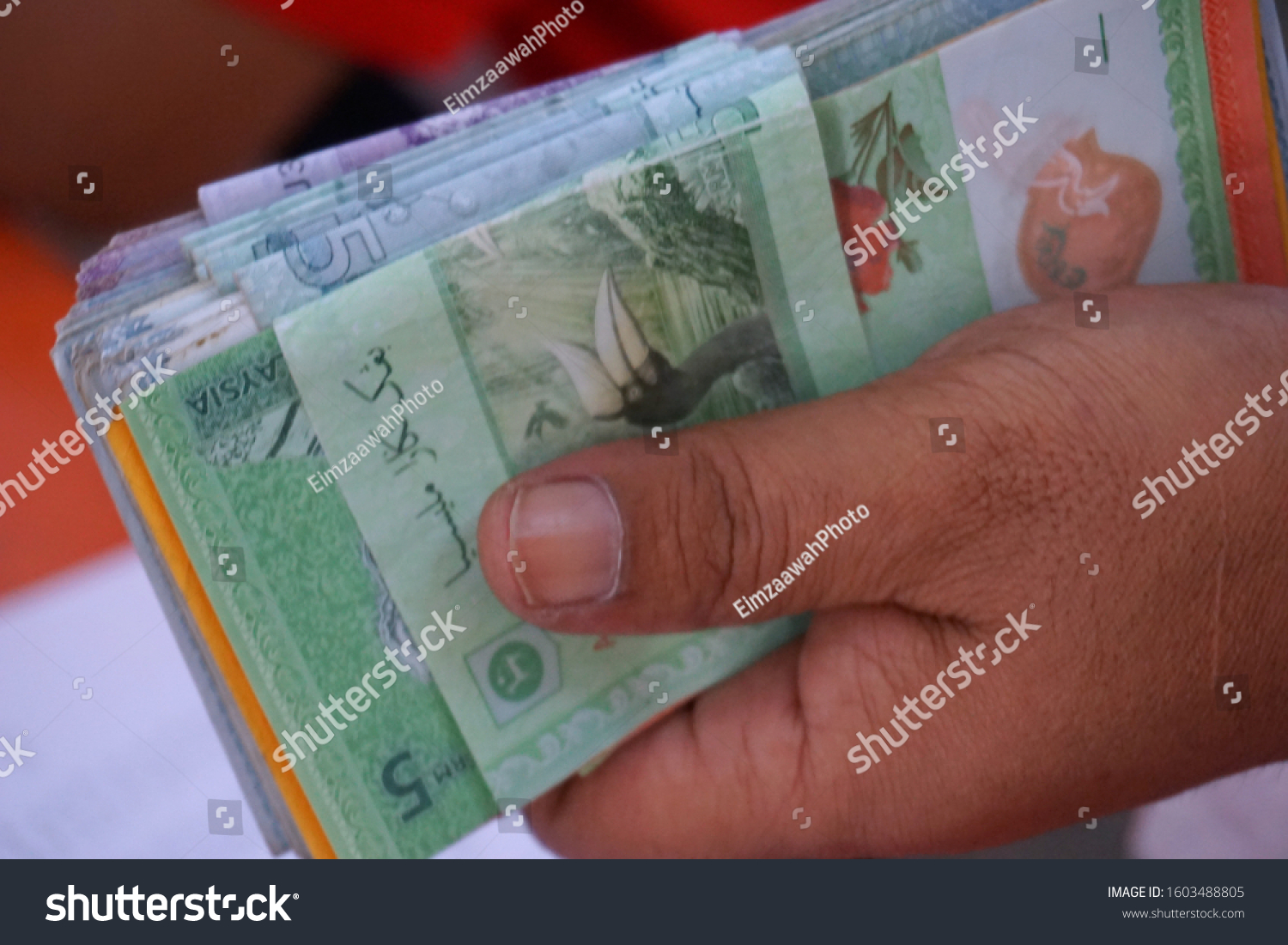 Malaysia money or bank notes stacking. Close up on Malaysia Ringgit money. Calculation to pay debts and daily expenses. Selective focus. #1603488805