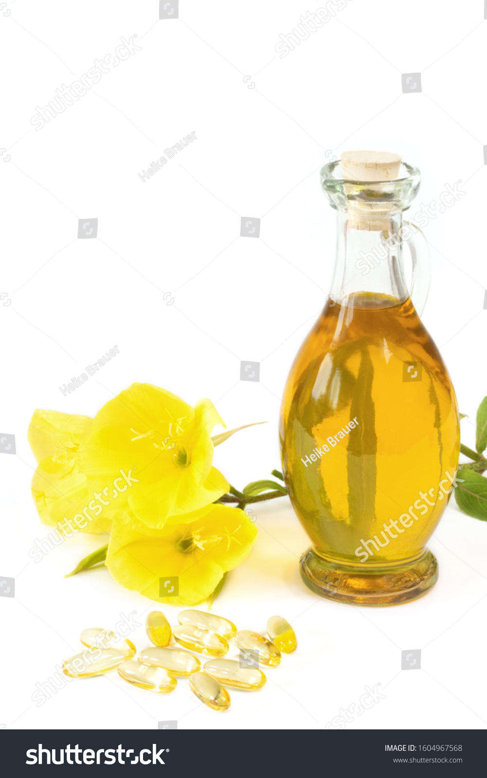 evening primroses with gelatine capsules and oil bottle on white background #1604967568