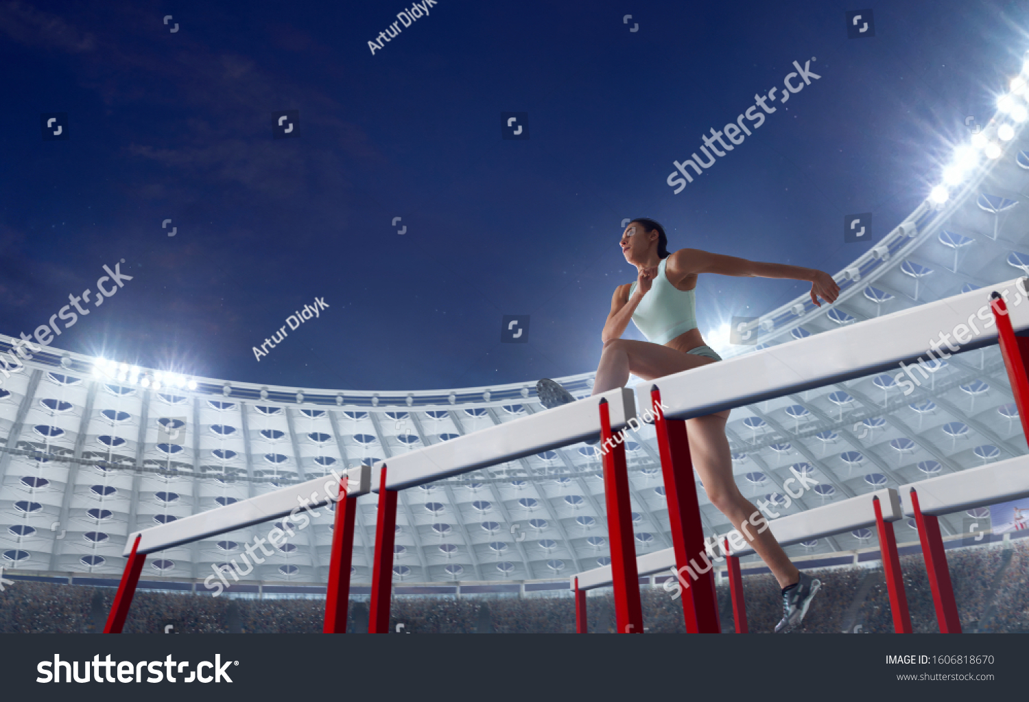Athlete woman athlete jumps over the barrier at the running track in professional athletics stadium. #1606818670
