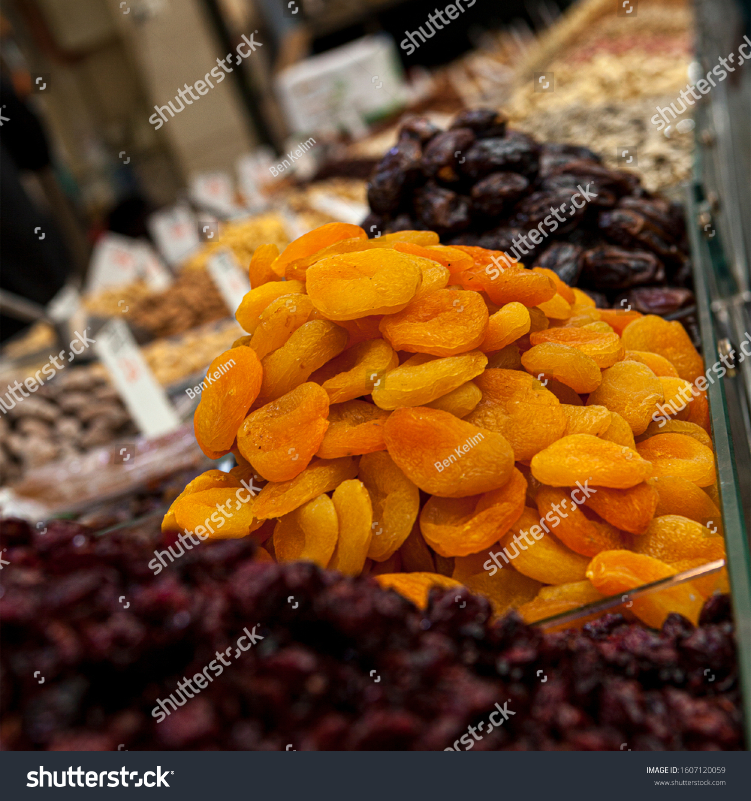 Mix of dried and sun-dried fruits, dried fruits in a wooden box on a white wooden background. View from above. Symbols of the Jewish holiday of Tu B'Shvat #1607120059