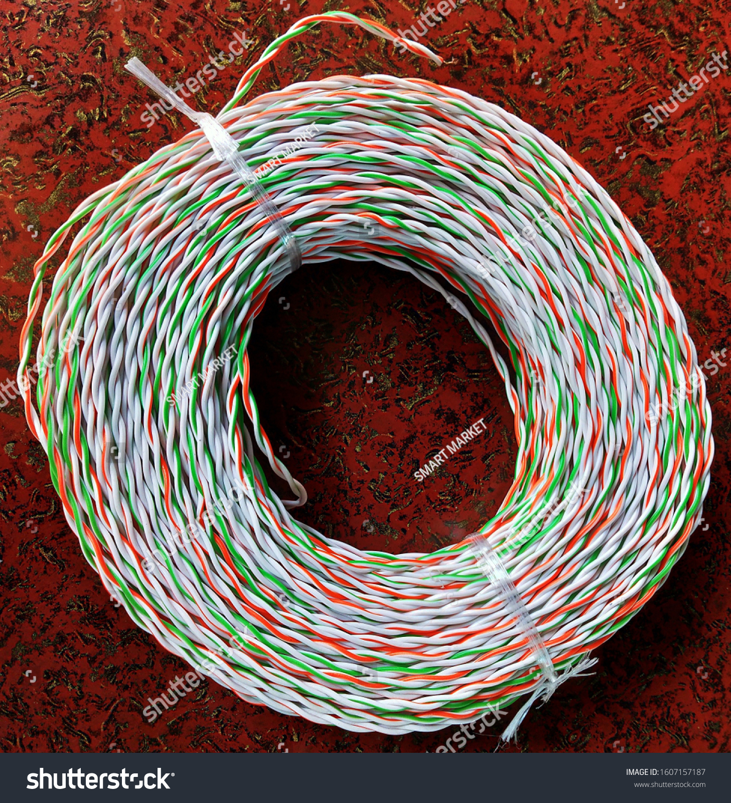 Colored wires and cables in electrical. Bundle of telecommunication multicolored cable in brown color background #1607157187
