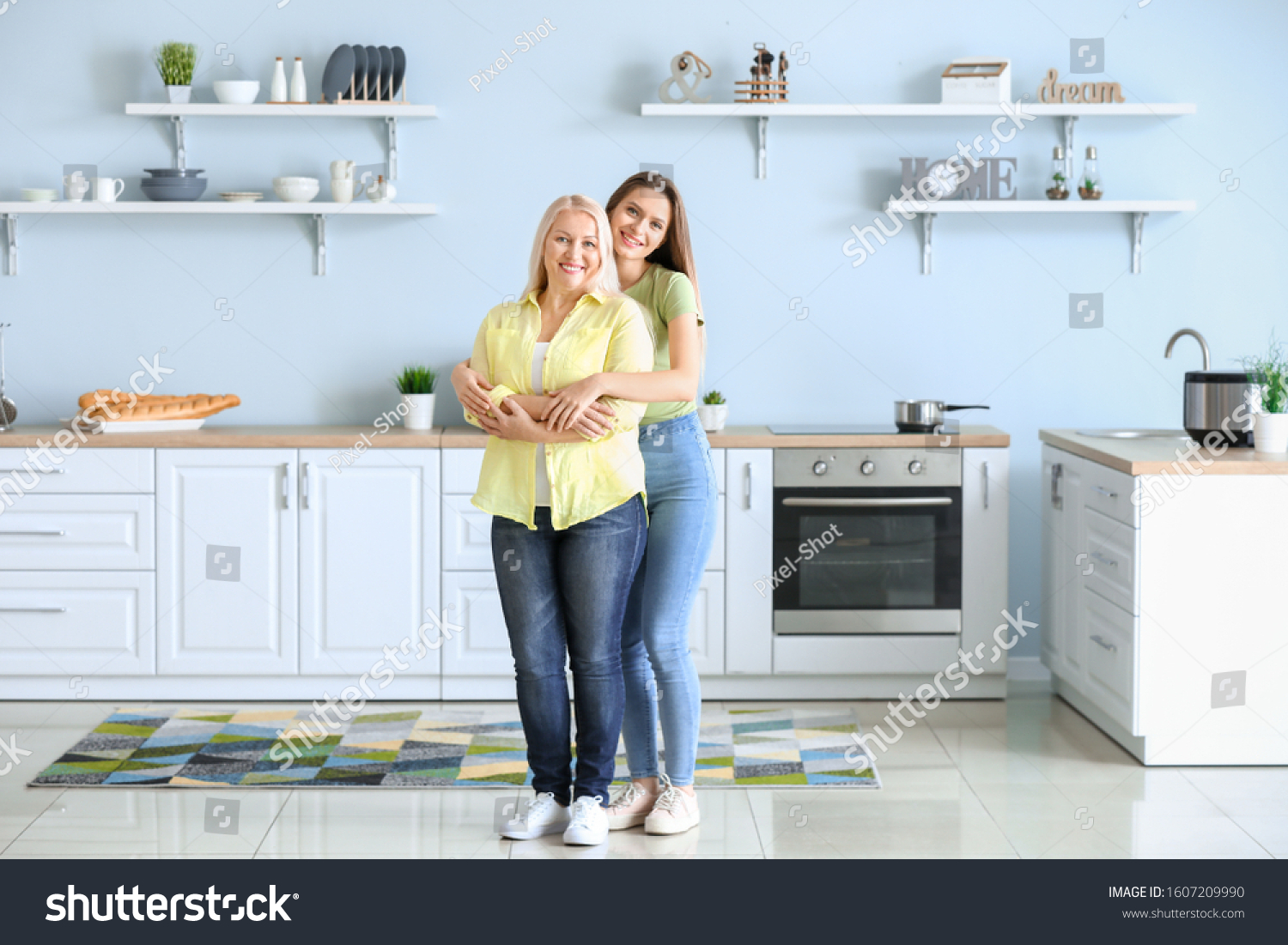 Mature woman and her adult daughter together in kitchen #1607209990