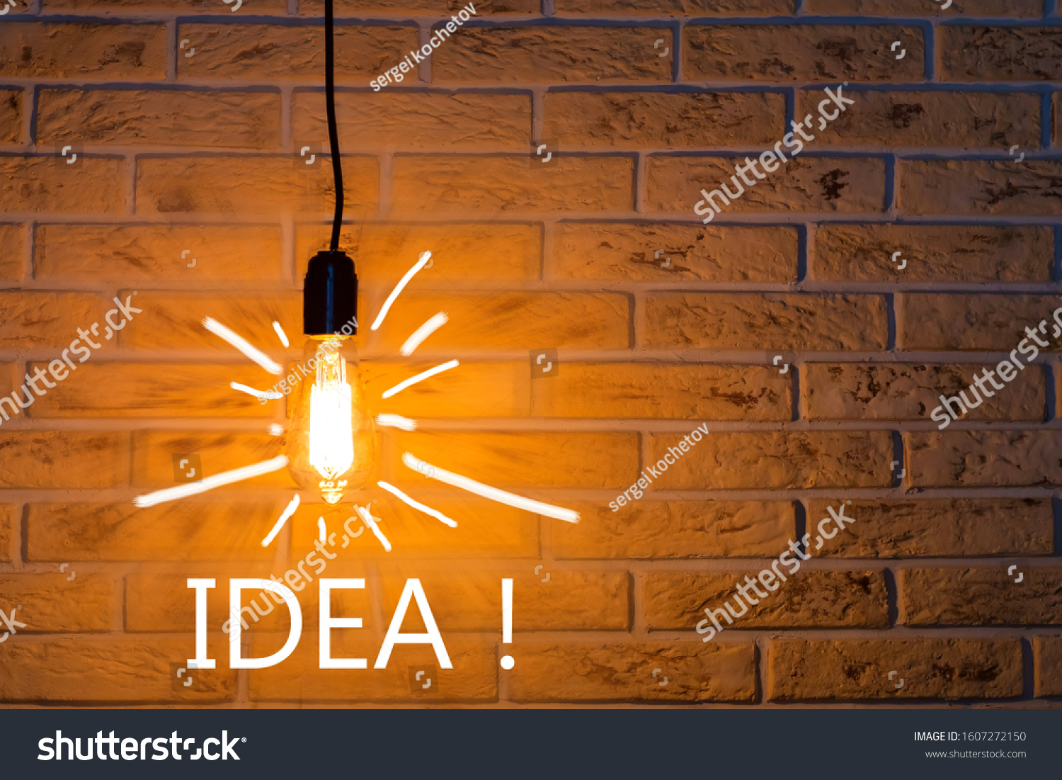 Vintage fashionable edison lamp on brick background with an inscription idea . Creative idea concept, designer lamp, modern interior item. Lighting, electricity, background with lamp. #1607272150