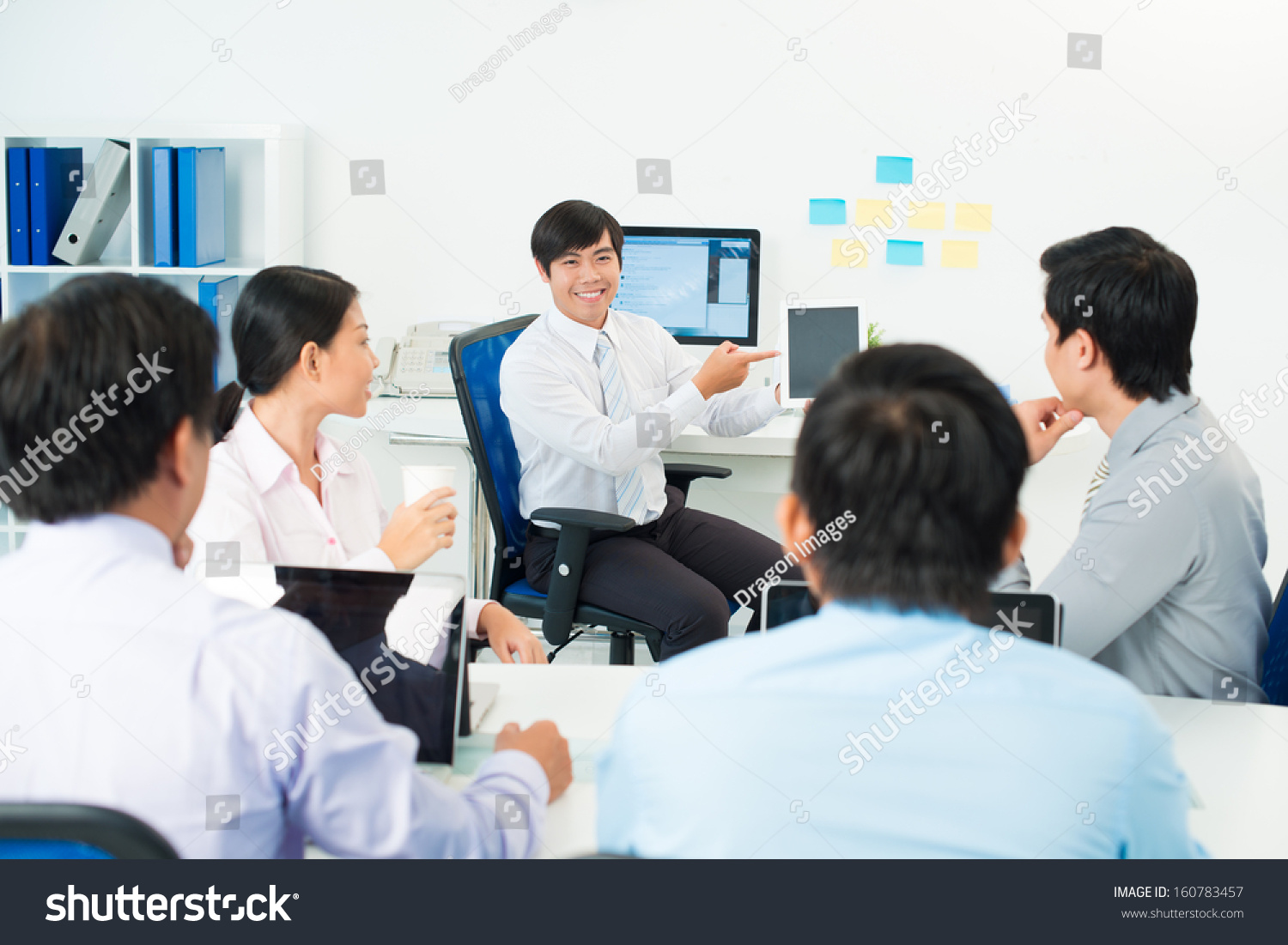 Image of a businessman presenting something at the seminar using tablet at the office on the foreground #160783457