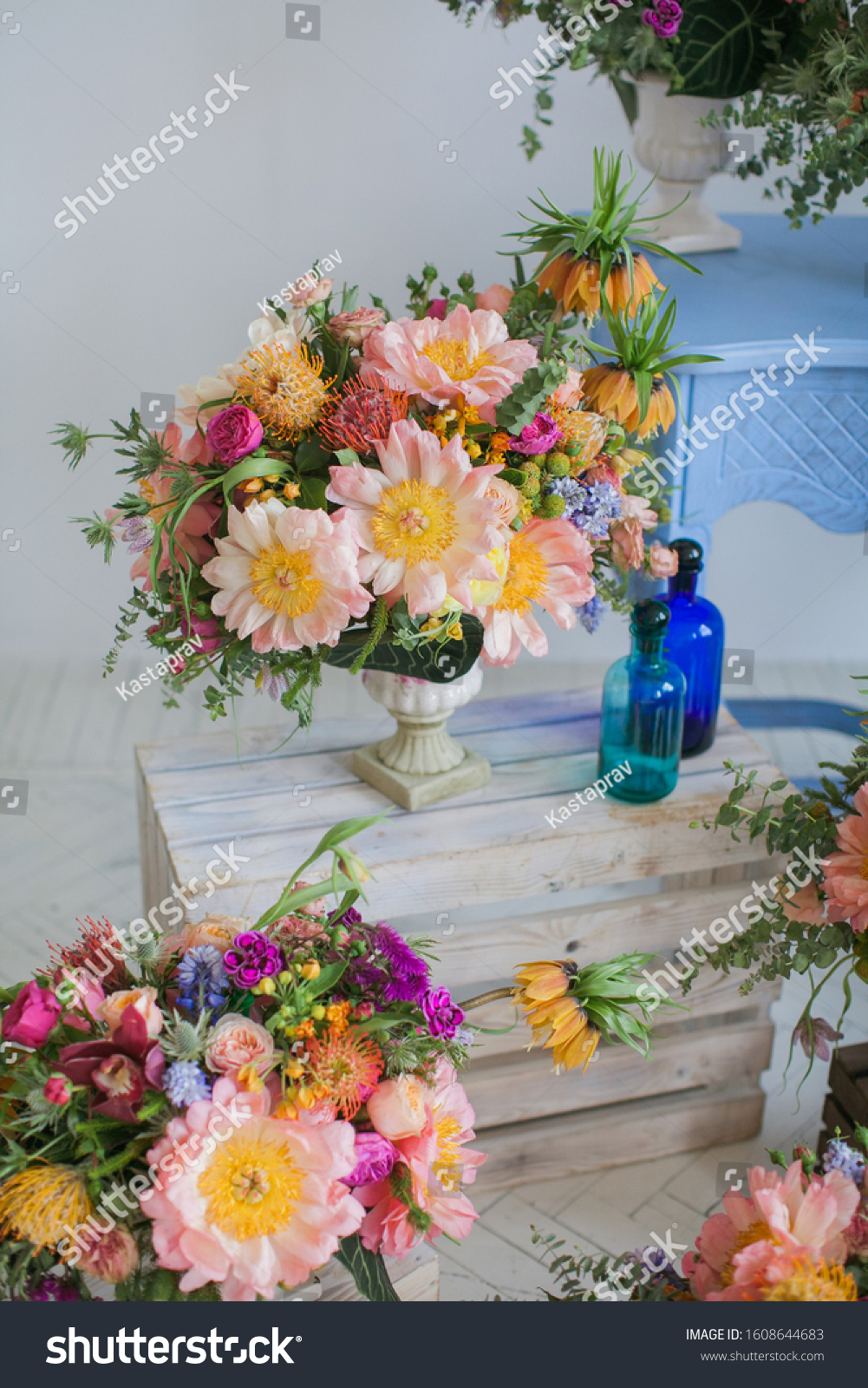 Workshop on creating a bouquet and floral arrangements from different plants in the style of boho chic. Pink peonies, red roses, green eucalyptus. Bouquets in ceramic wooden coasters. For weddings. #1608644683