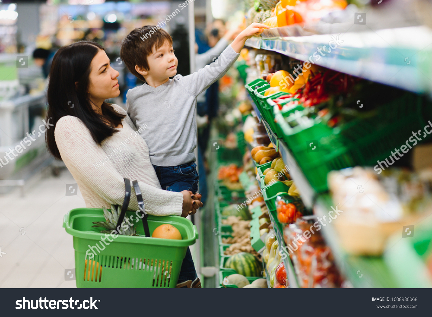 Young mother with her little baby boy at the supermarket. Healthy eating concept #1608980068