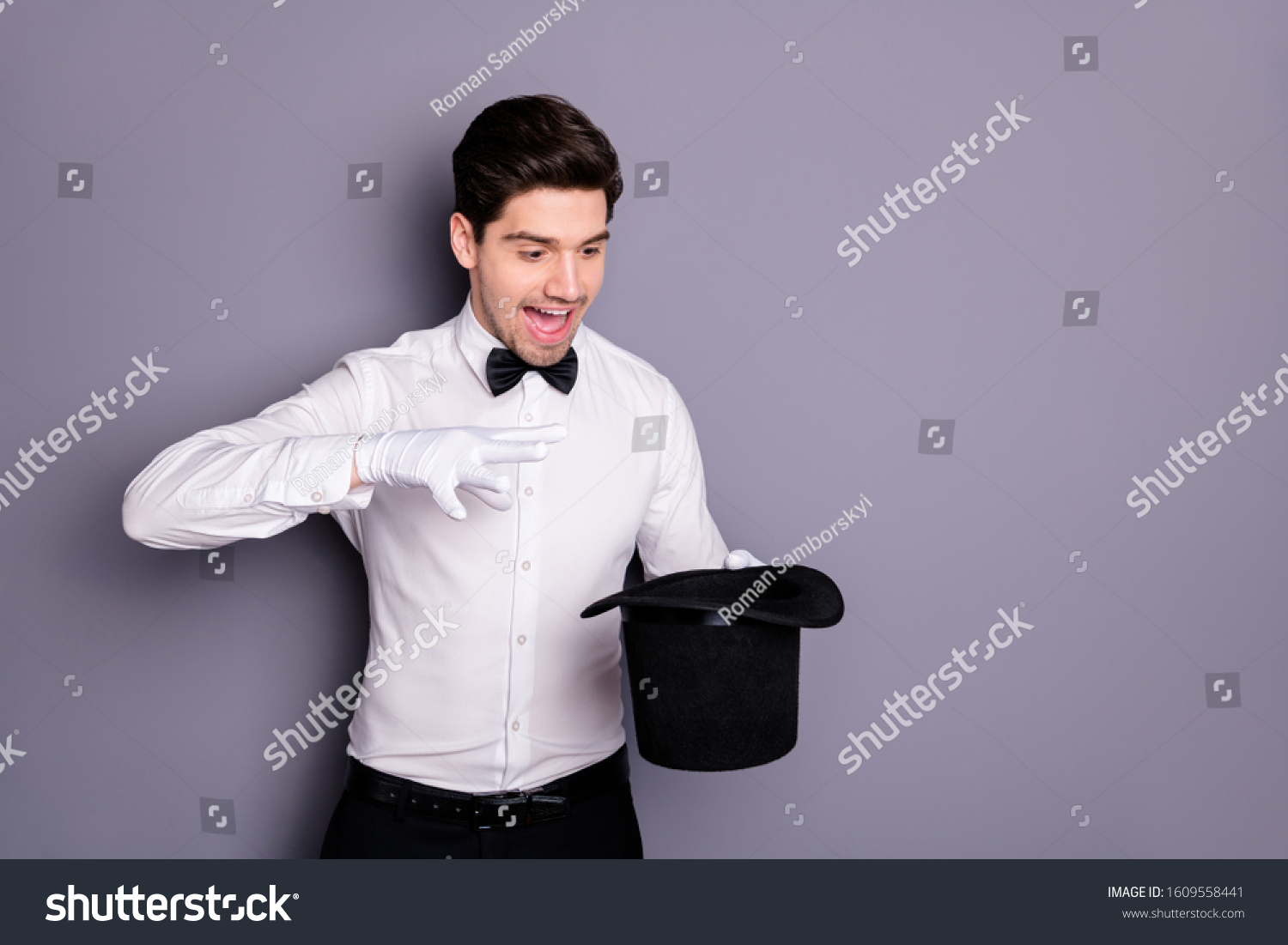 Portrait of crazy magician hold hand black cylinder hat make spell abracadbra entertain circus audience wear formalwear clothing isolated over grey color background #1609558441
