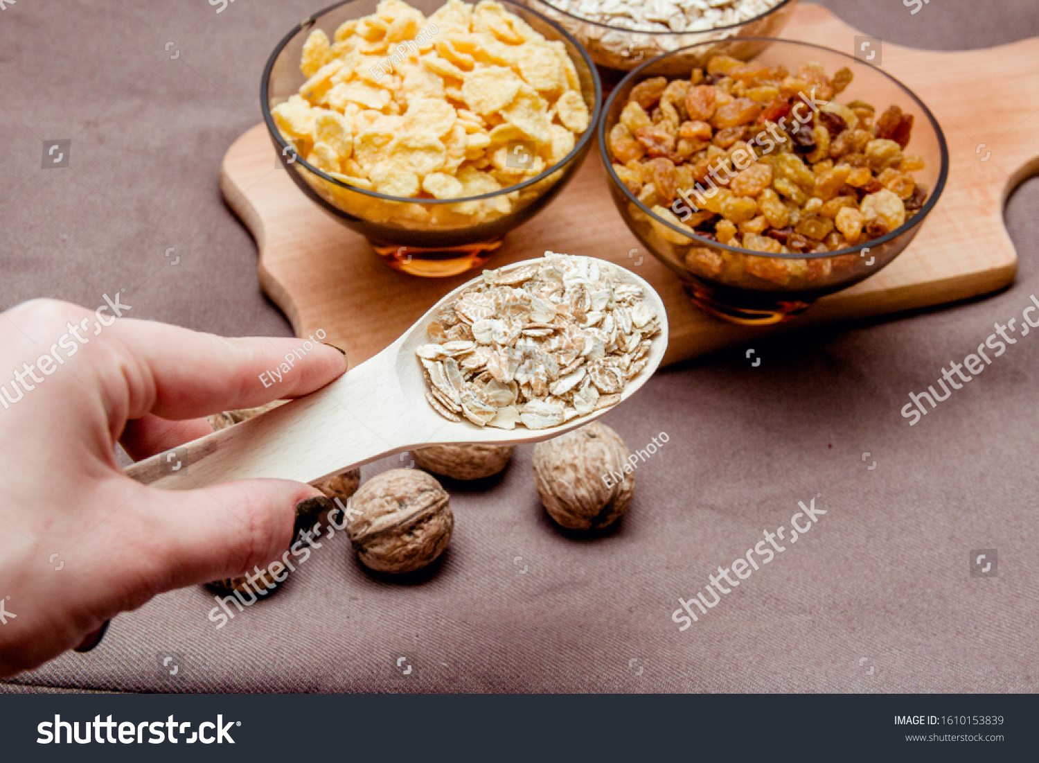 variations of cereals, raisins and walnuts on a decorative background #1610153839
