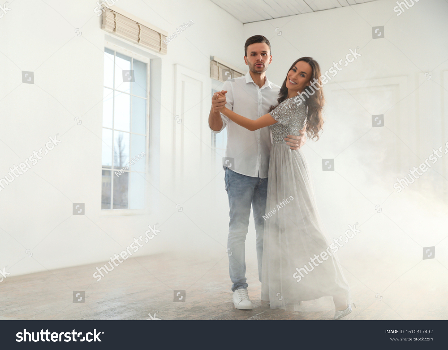 Lovely young couple dancing together in ballroom. Space for text #1610317492