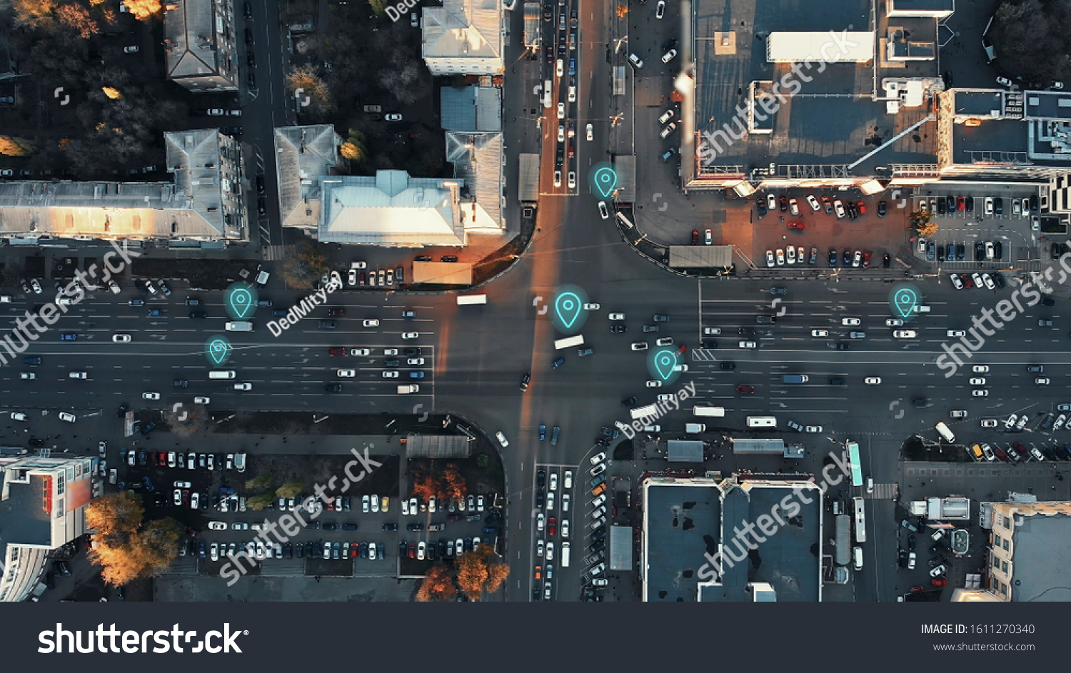 Aerial view of city intersection with many cars and GPS navigation system symbols. Autonomous driverless vehicles in city traffic. Future transportation concept. #1611270340