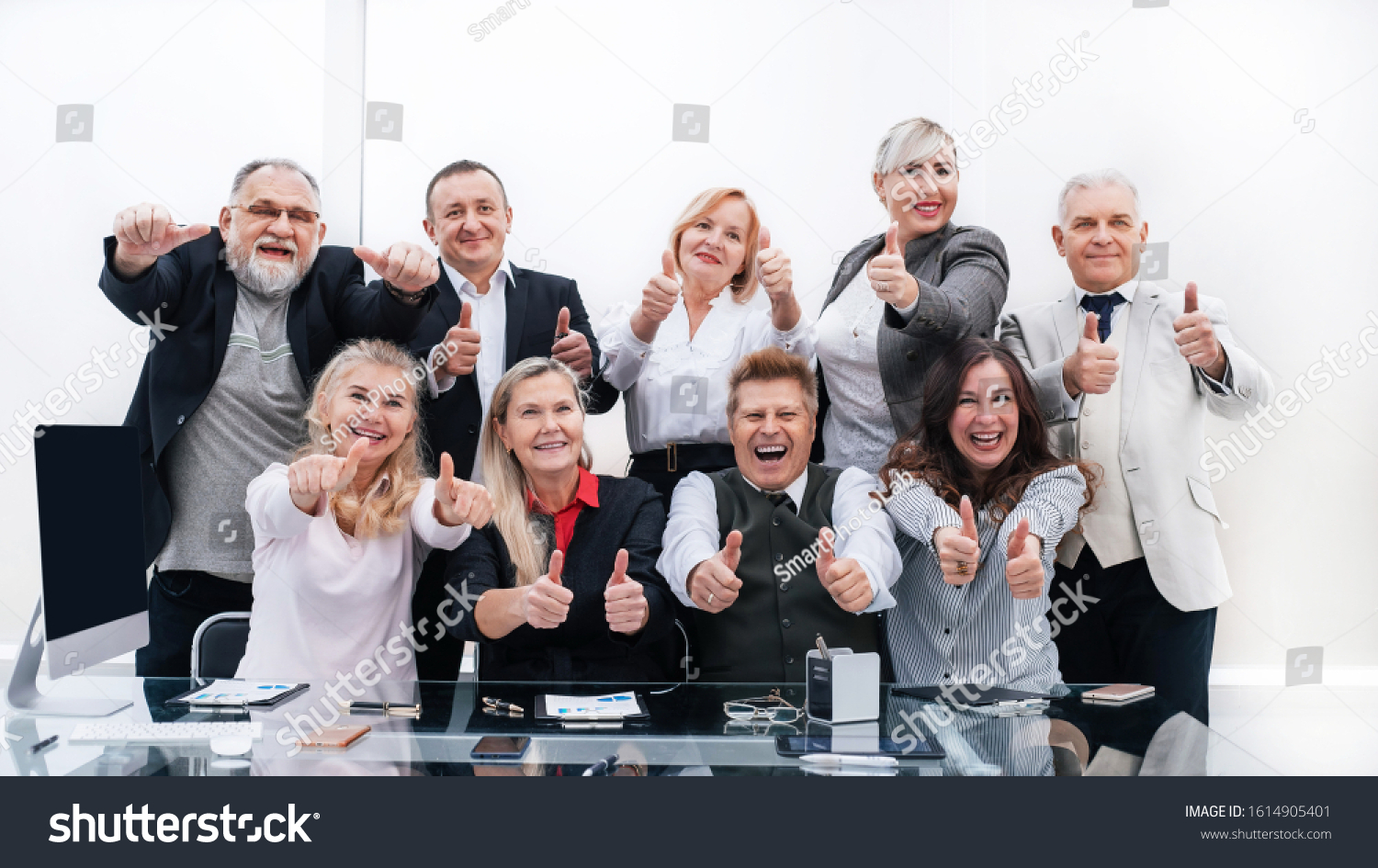 large group of happy employees showing their success #1614905401