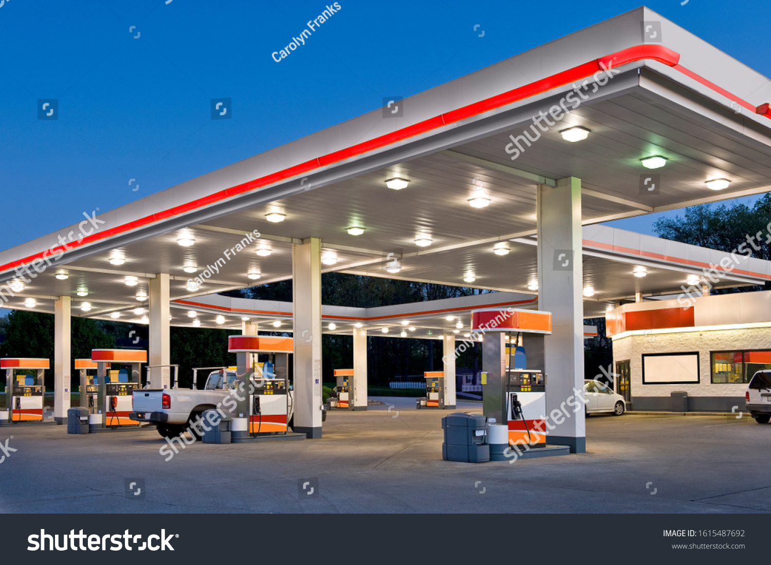 Horizontal shot of a retail gasoline station and convenience store at dusk. #1615487692