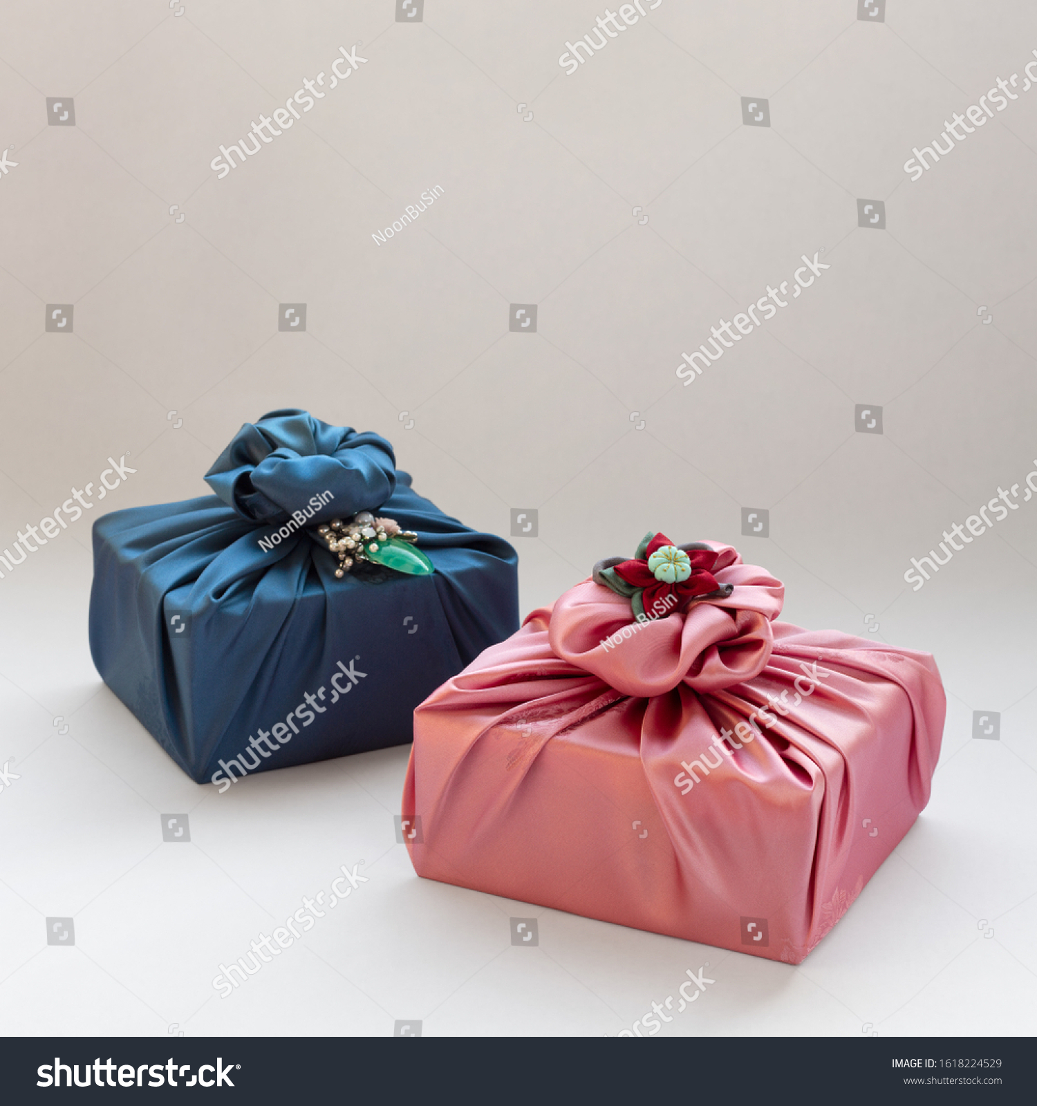 Korean traditional gift packaging cloth made of silk(bojagi) and ornaments with copy space. Isolated on white background. #1618224529