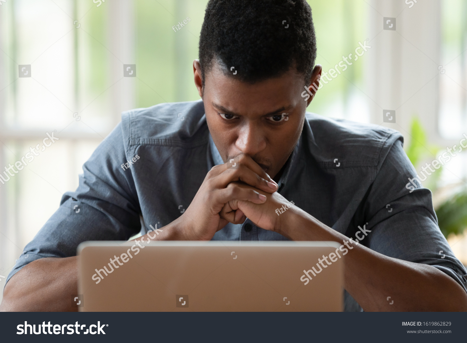 Stressed unhappy African American businessman looking at laptop screen close up, reading bad news in email, dismissal, bankruptcy or loss money, depressed employee frustrated by financial problem #1619862829