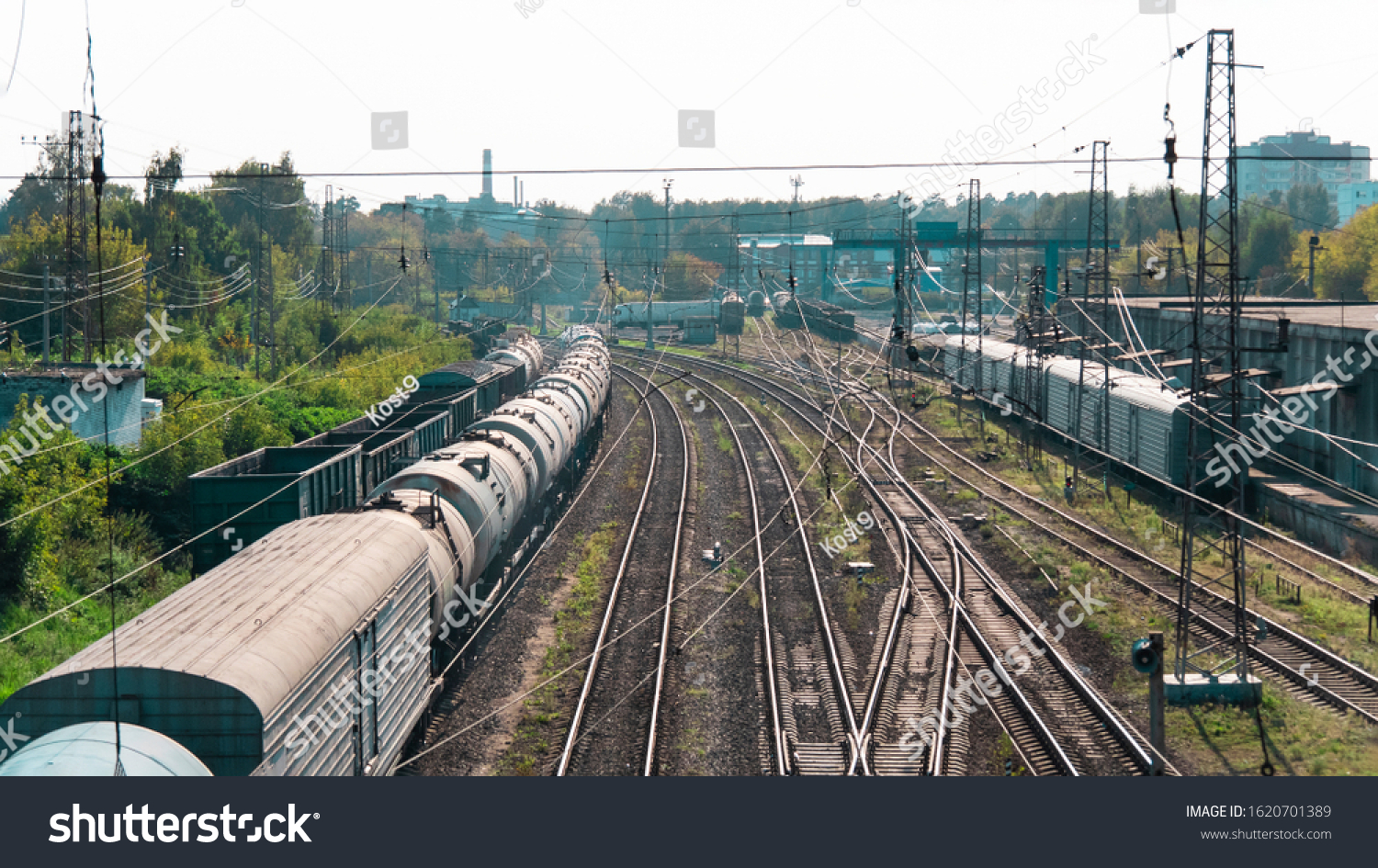 Freight train wagons. Transportation station. Transport industry background. Freight trains with gondola cars, tanks and a refrigerator car for transporting goods by rail. Business logistics,import.  #1620701389