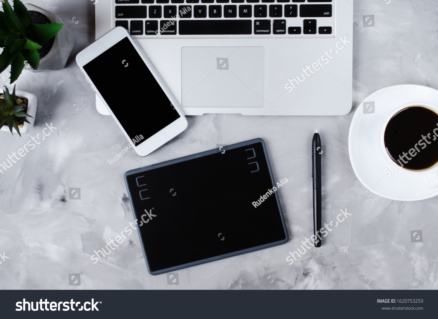 Overhead view of graphic tablet, graphic pen, smartphone, laptop and a cup of black coffee. #1620753259