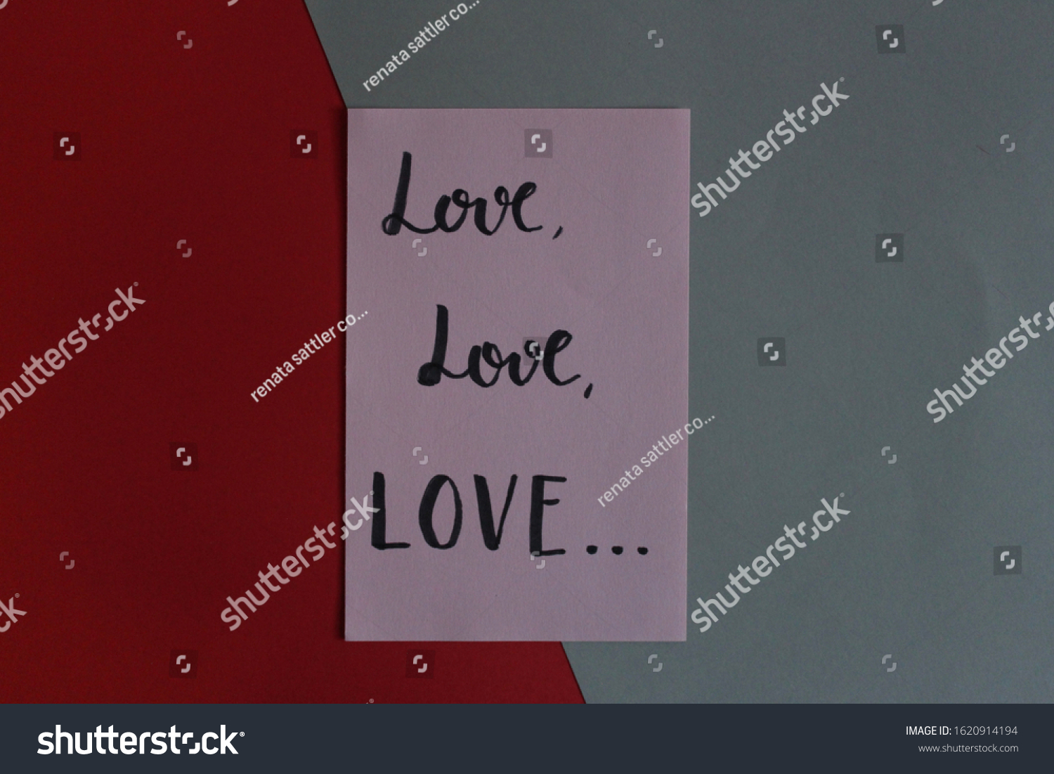 “Love love love” handwritten on pink paper about art composition on colored papers gray and red #1620914194
