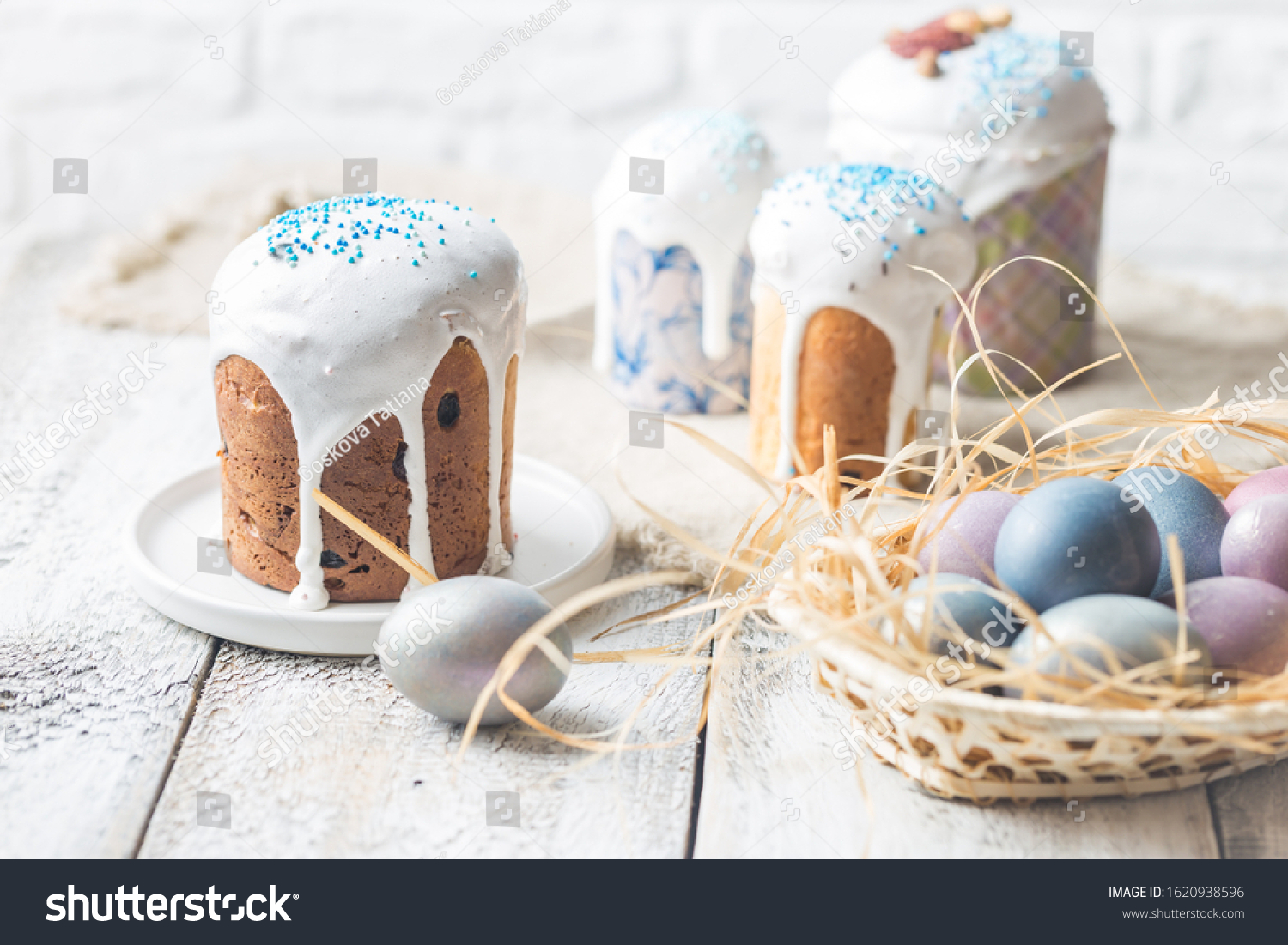 Easter table with Easter cakes and Easter eggs over white background #1620938596