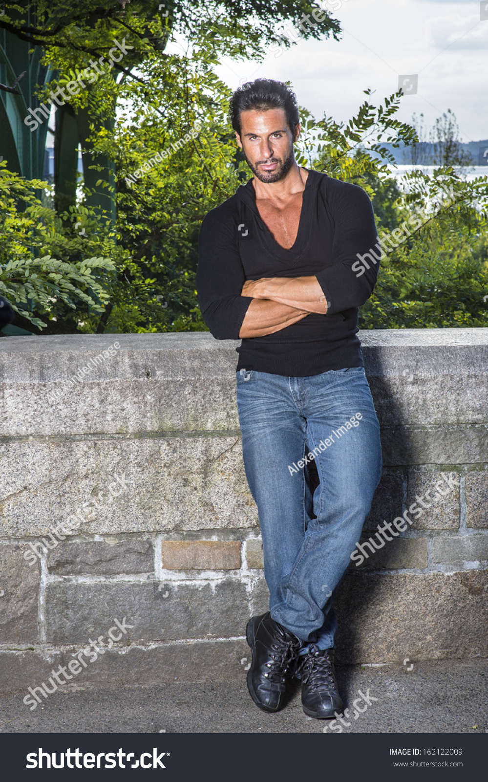 Dressing in a black sweater, blue jeans 