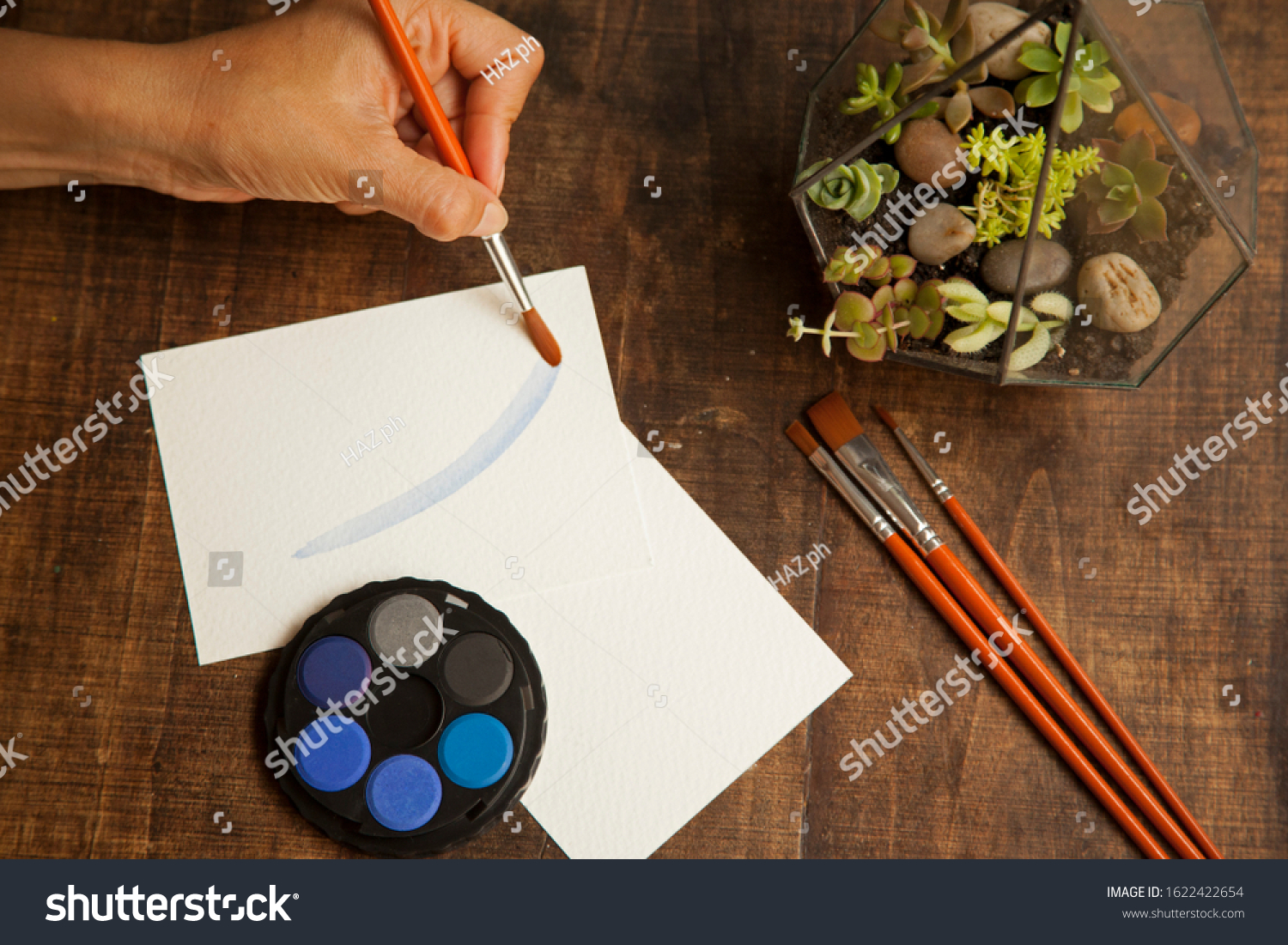 blank sheet on the table with paintbrushes and watercolor #1622422654