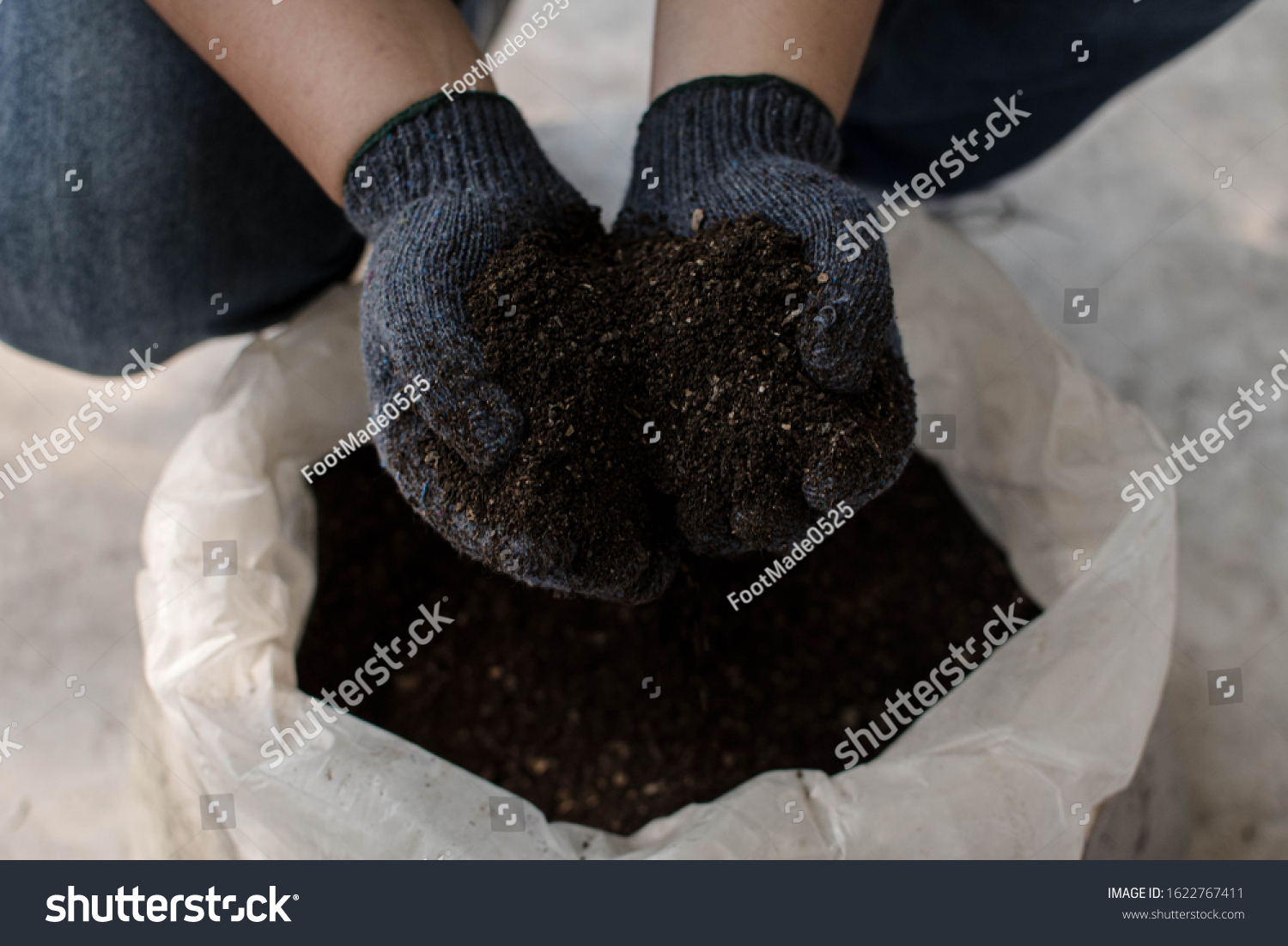 Hand holding organic fertilizer background. Organic fertilizer for organic fruits and vegetables. #1622767411
