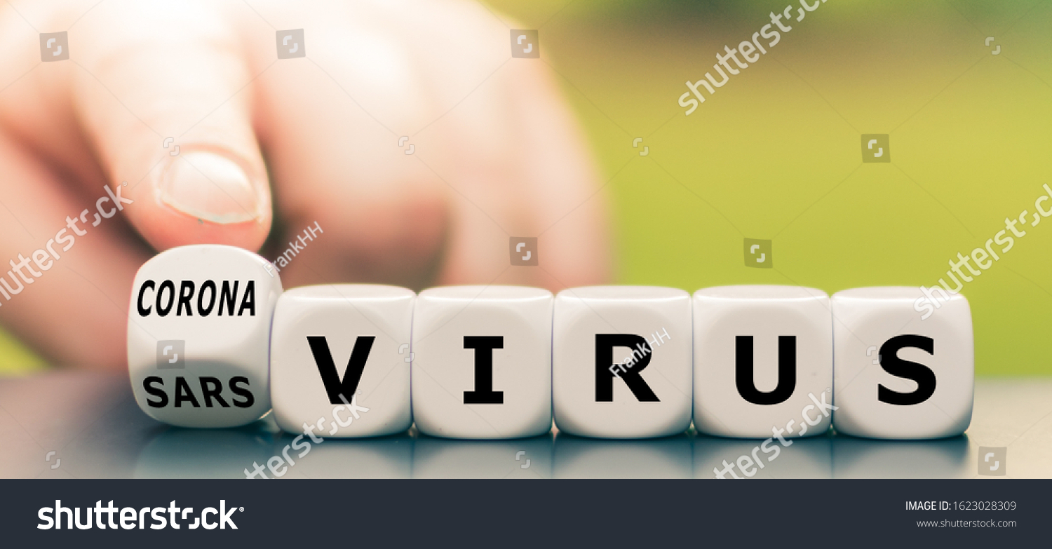 Hand turns a dice and changes the expression "sars virus" to "corona virus". #1623028309