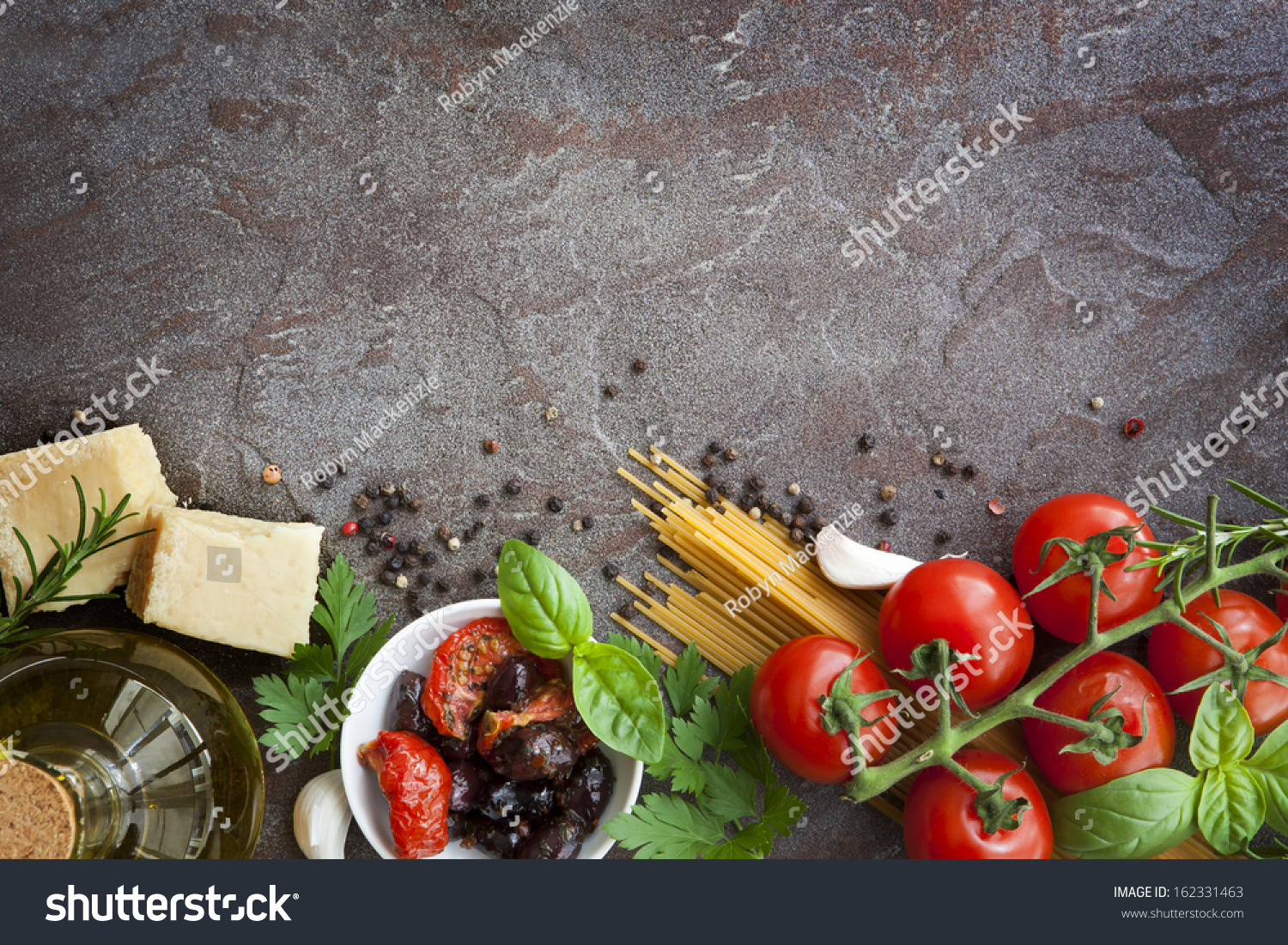 Italian food background, with vine tomatoes, basil, spaghetti, mushrooms, olives, parmesan, olive oil, garlic, peppercorns, rosemary, parsley and thyme.  Slate background. #162331463