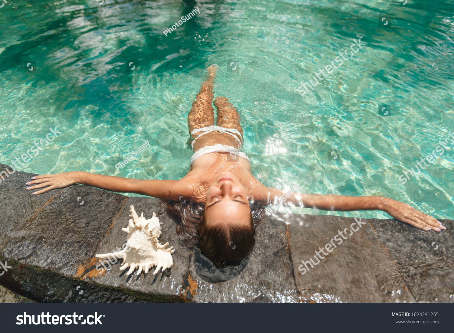 Woman relaxing in swimming-pool. lying on the back with closed eyes. Relax and spa concept #1624291255