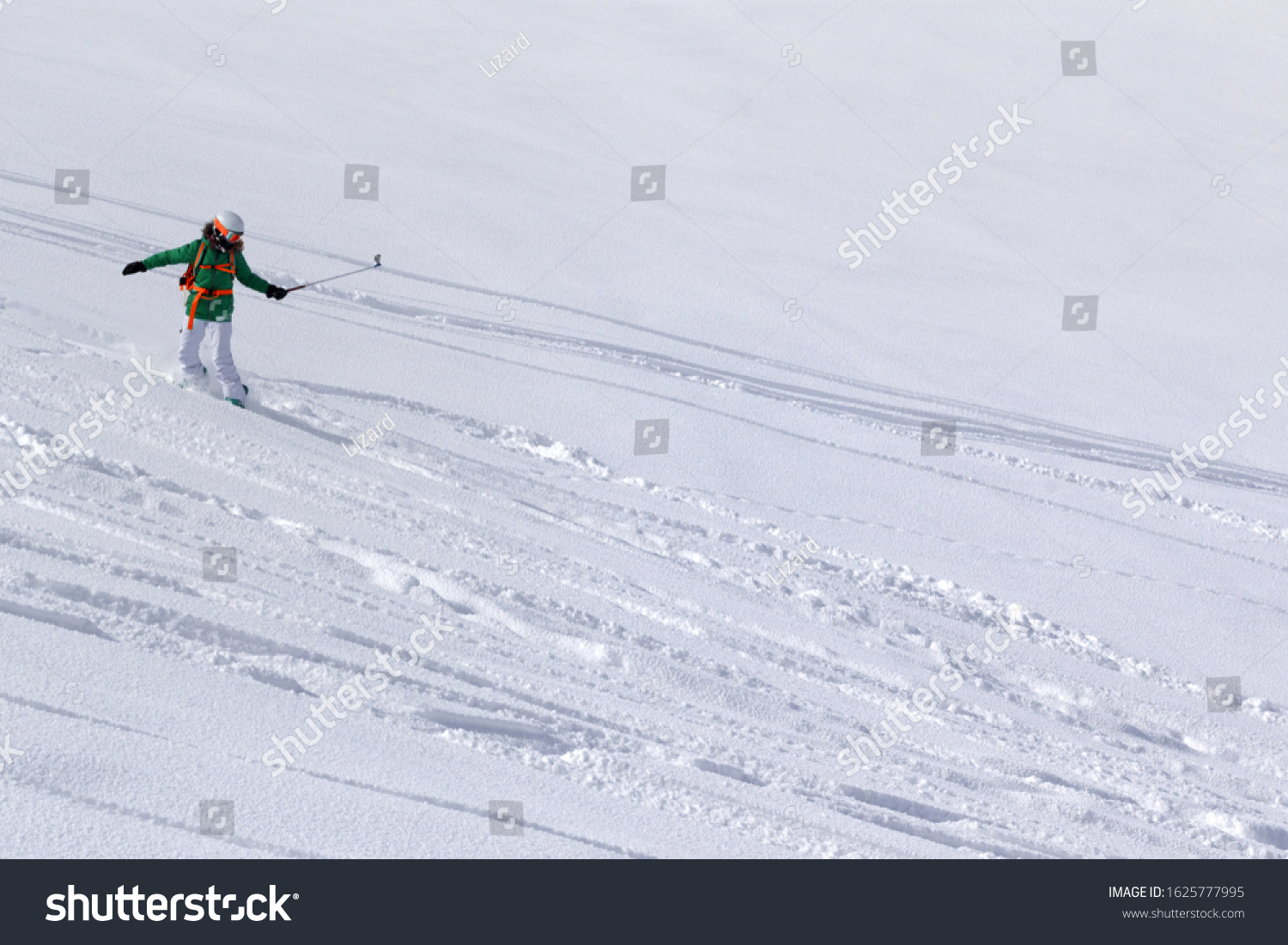 Snowboarder downhill on snowy off piste slope with newly-fallen snow at high winter mountains #1625777995