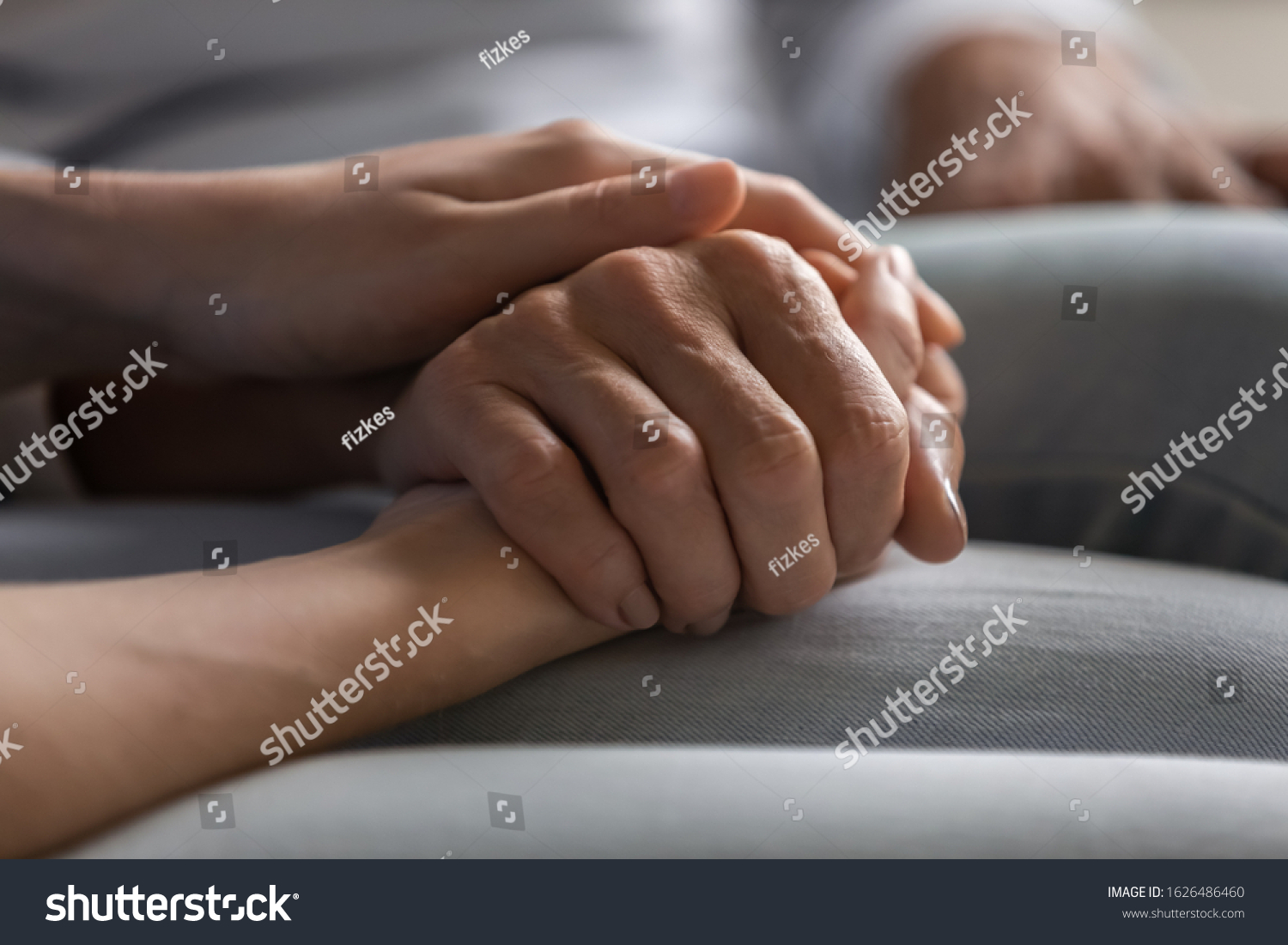 Close up young woman holding hand of elderly lady, having heart-to-heart sincere trustful conversation. Compassionate grown up daughter supporting older mother, overcoming problems together. #1626486460