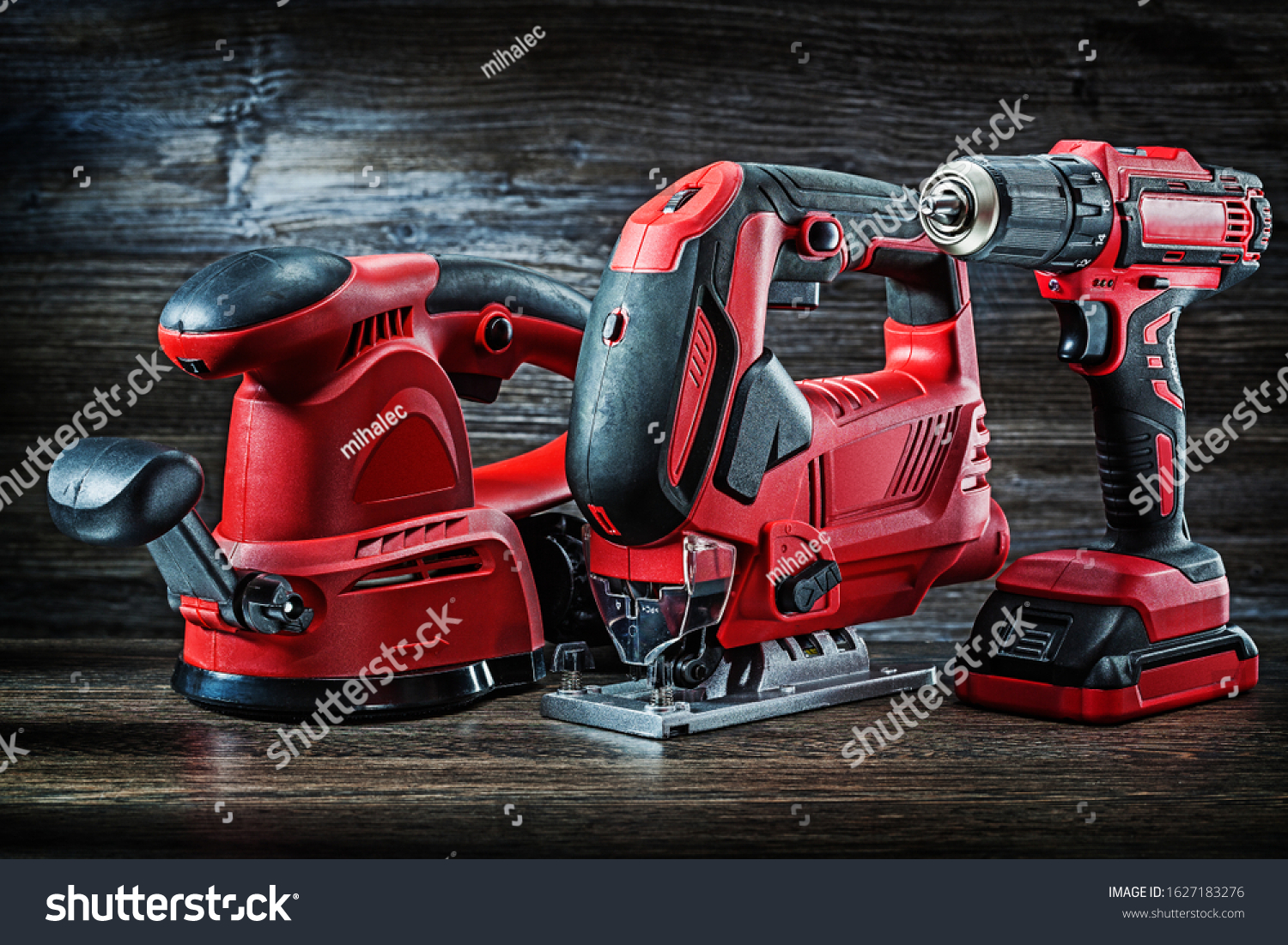 electric hand tools red corded jigsaw cordless drill and speed variable power small plunge router milling machine portable mini wood router on vintage wooden background #1627183276