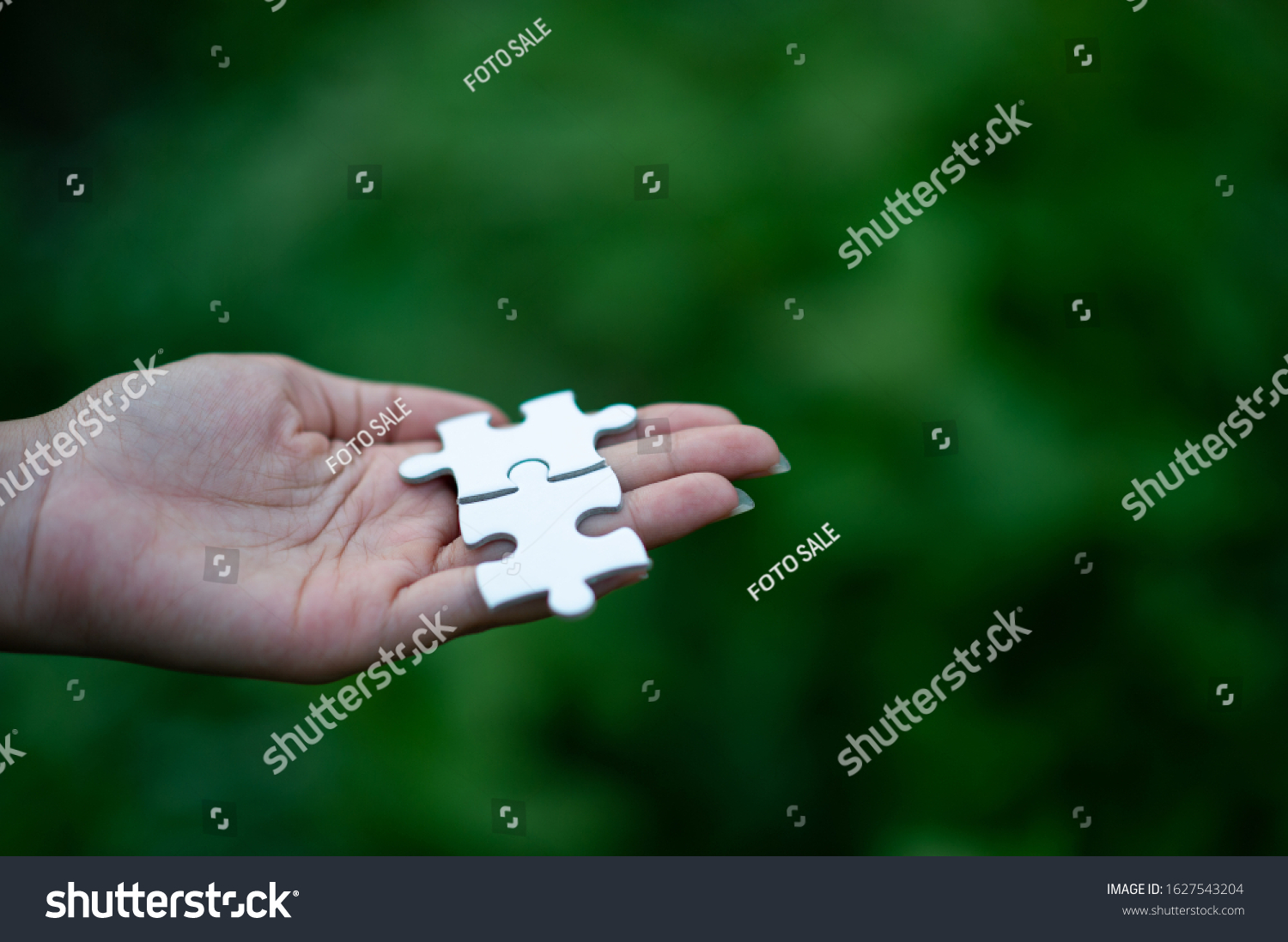 Hands and puzzles, important pieces of teamwork Teamwork concept #1627543204