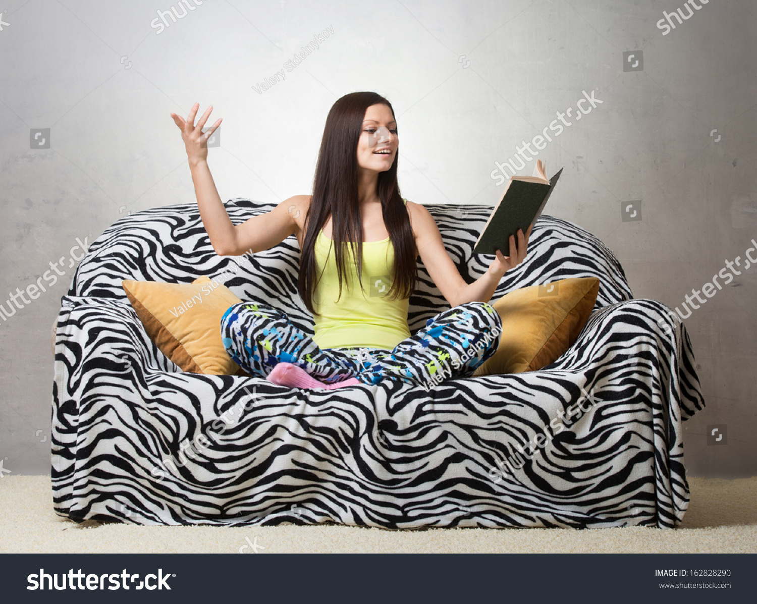 Inspired girl sitting on the sofa and reciting a poem #162828290