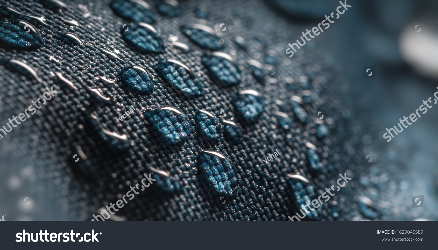 Close-up view on water drops on waterproof impregnated fabric in rain. #1629045589