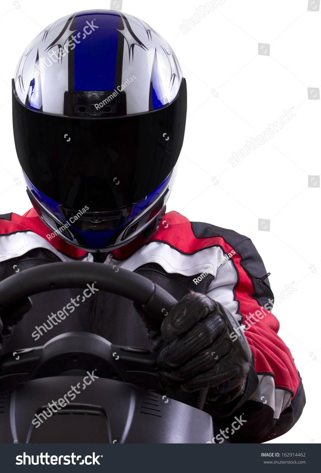 racerwearing red racing suit and blue helmet on a steering wheel #162914462