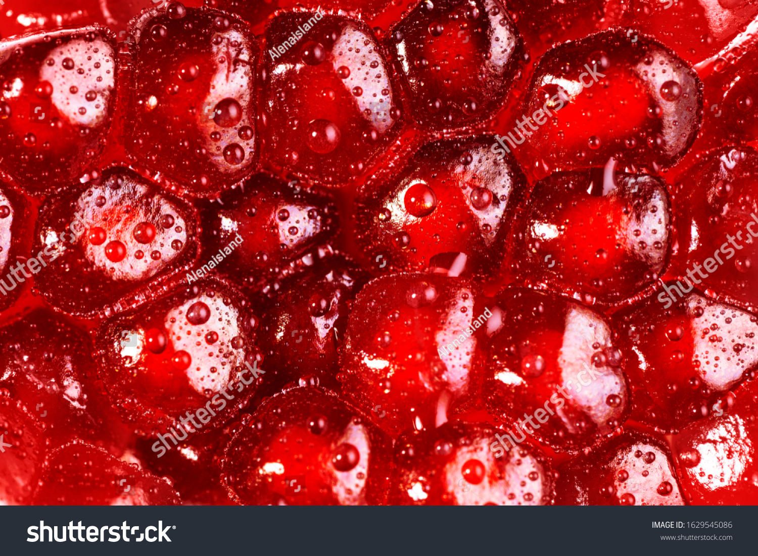 Pomegranate seeds close up background. Texture water drops on exotic fruit. #1629545086