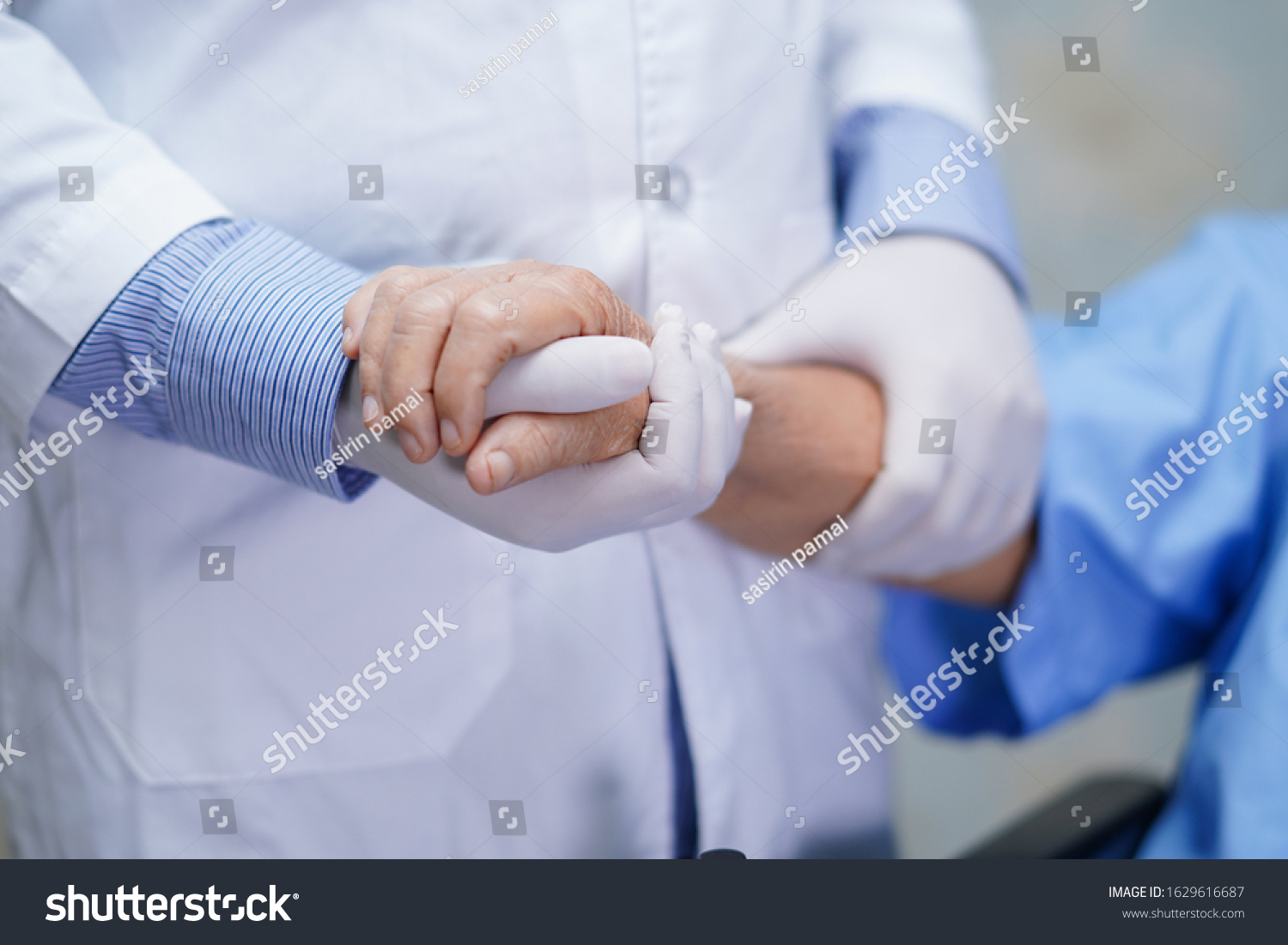 Doctor holding touching hands Asian senior or elderly old lady woman patient with love, care, helping, encourage and empathy at nursing hospital ward : healthy strong medical concept 
 #1629616687