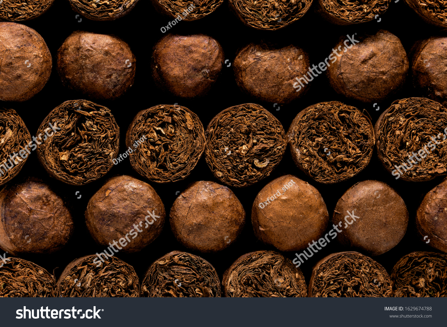 Cuban Cigars: Close up of luxury hand made cigars stacked in a storage box. Tobacco display background or wall art. #1629674788