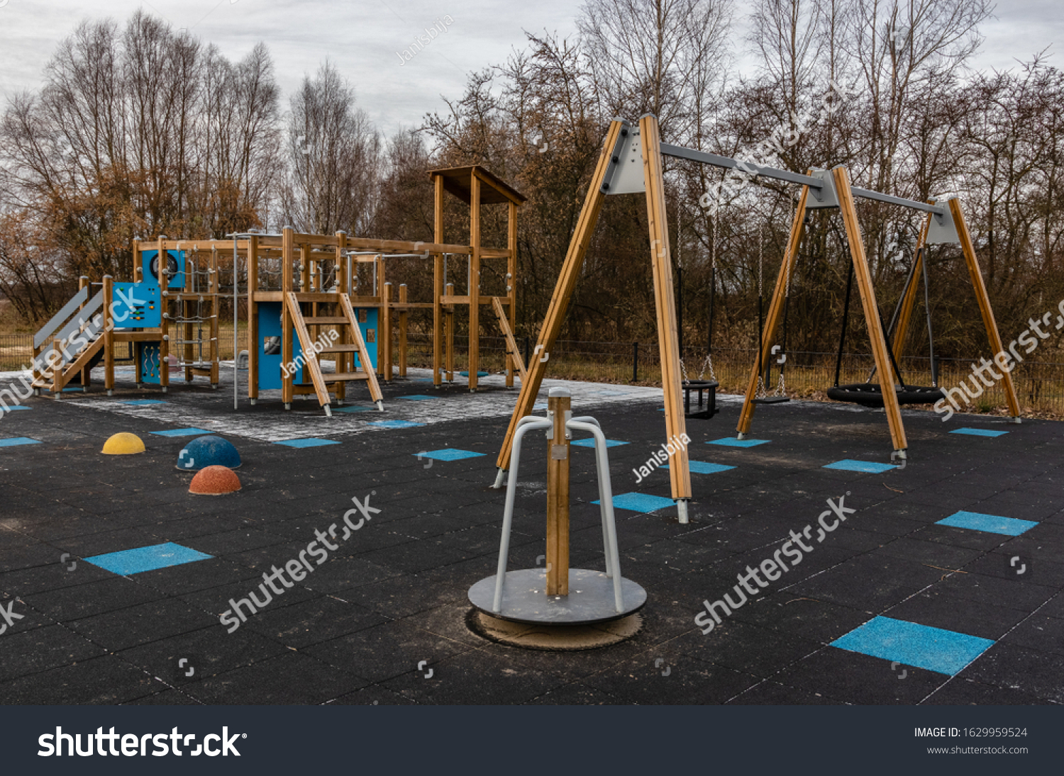 Children's playground with artificial cover, slide and swing. Leisure time, Healthy, active lifestyle #1629959524